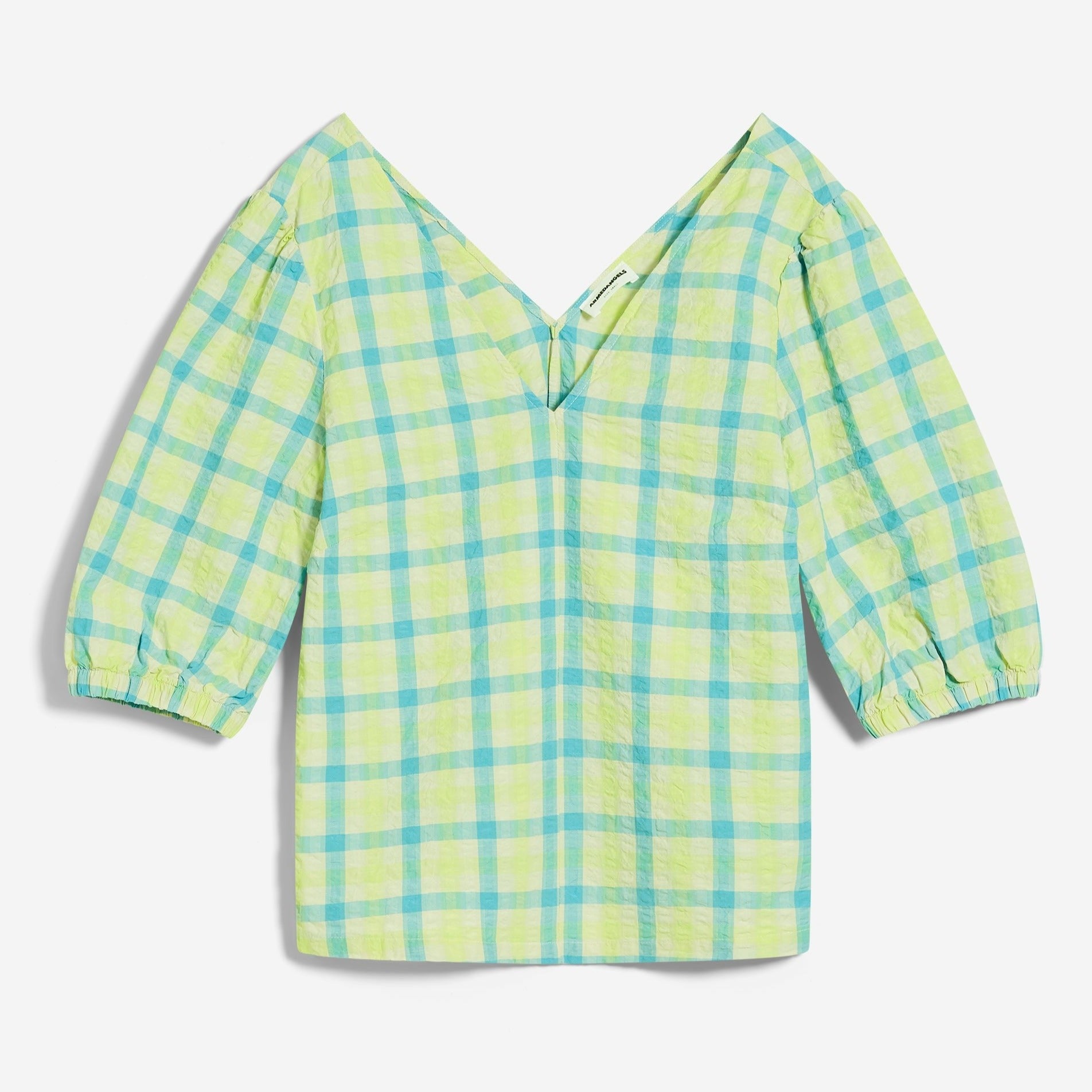 Kariertes grün-blaues Oberteil mit V-Ausschnitt und halblangen Puffärmeln.