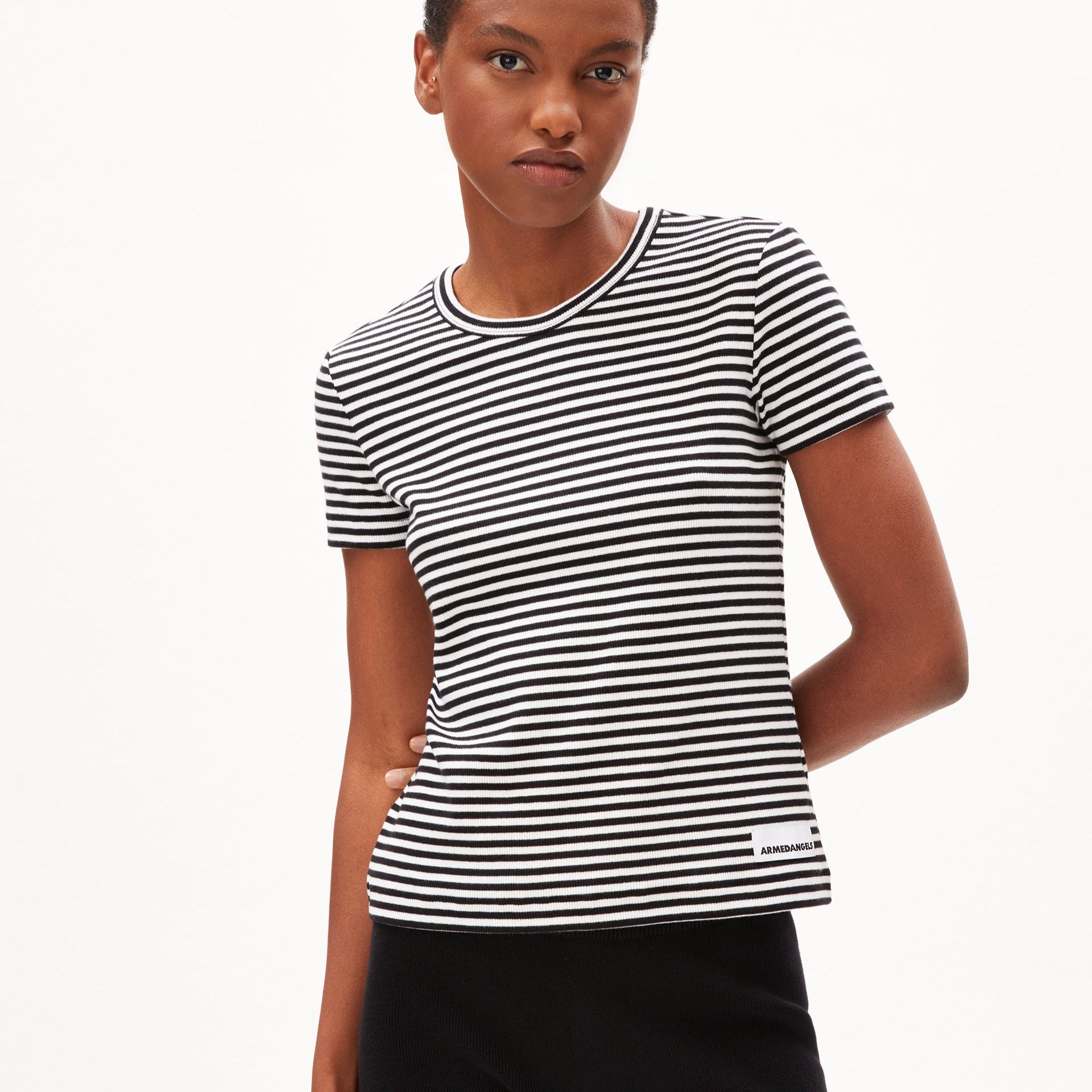 Person in a black and white striped t-shirt standing against a plain white background.