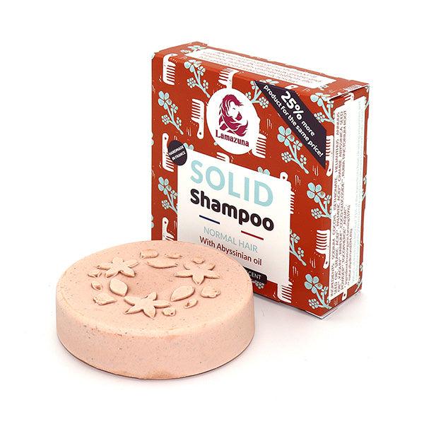 Rundes festes Shampoo mit Blumenmuster vor einer Verpackung mit floralem Design und der Aufschrift "Solid Shampoo".
