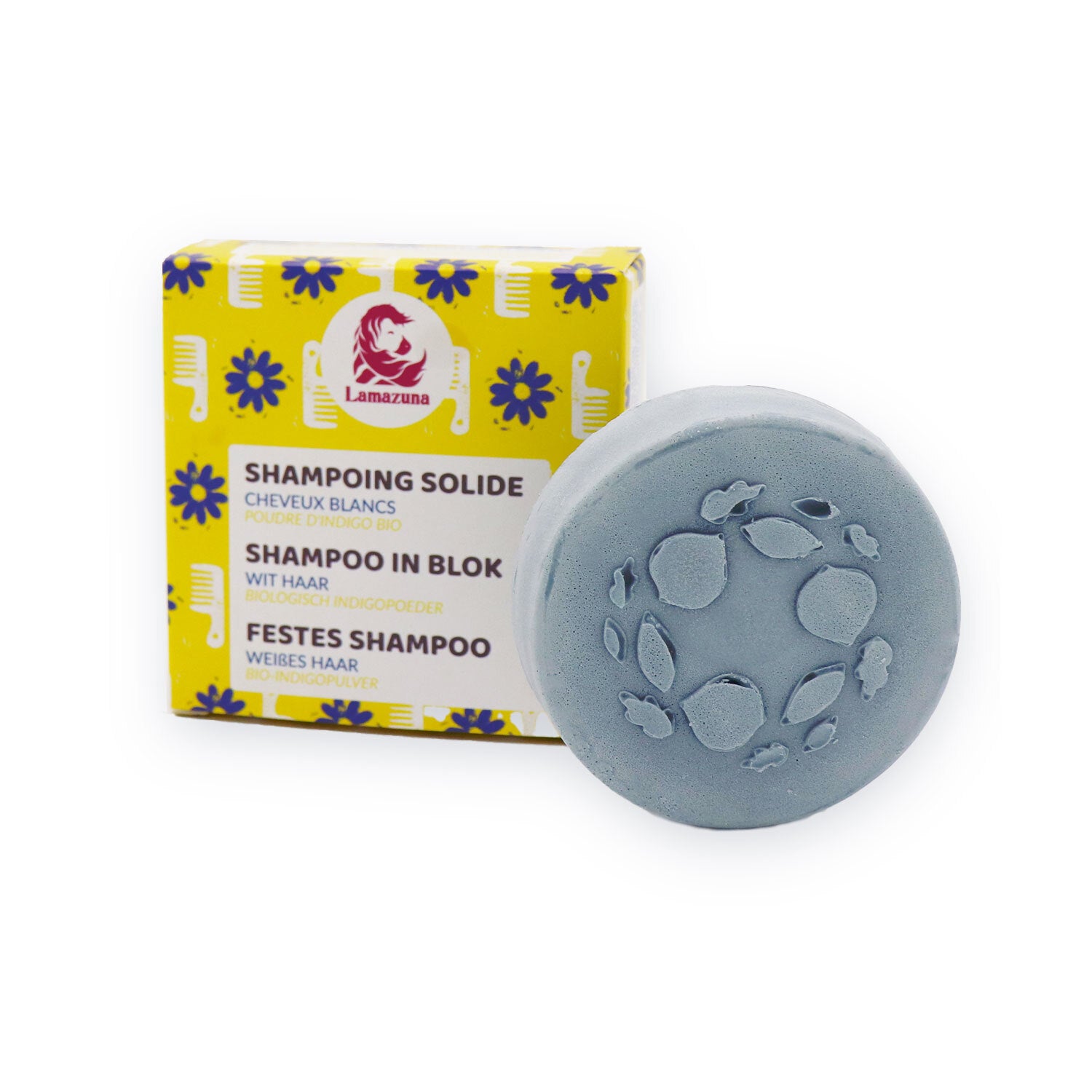 Runde, graue feste Shampoo-Seife neben einer gelben Verpackung mit blauen Blüten und der Aufschrift "Lamazuna".
