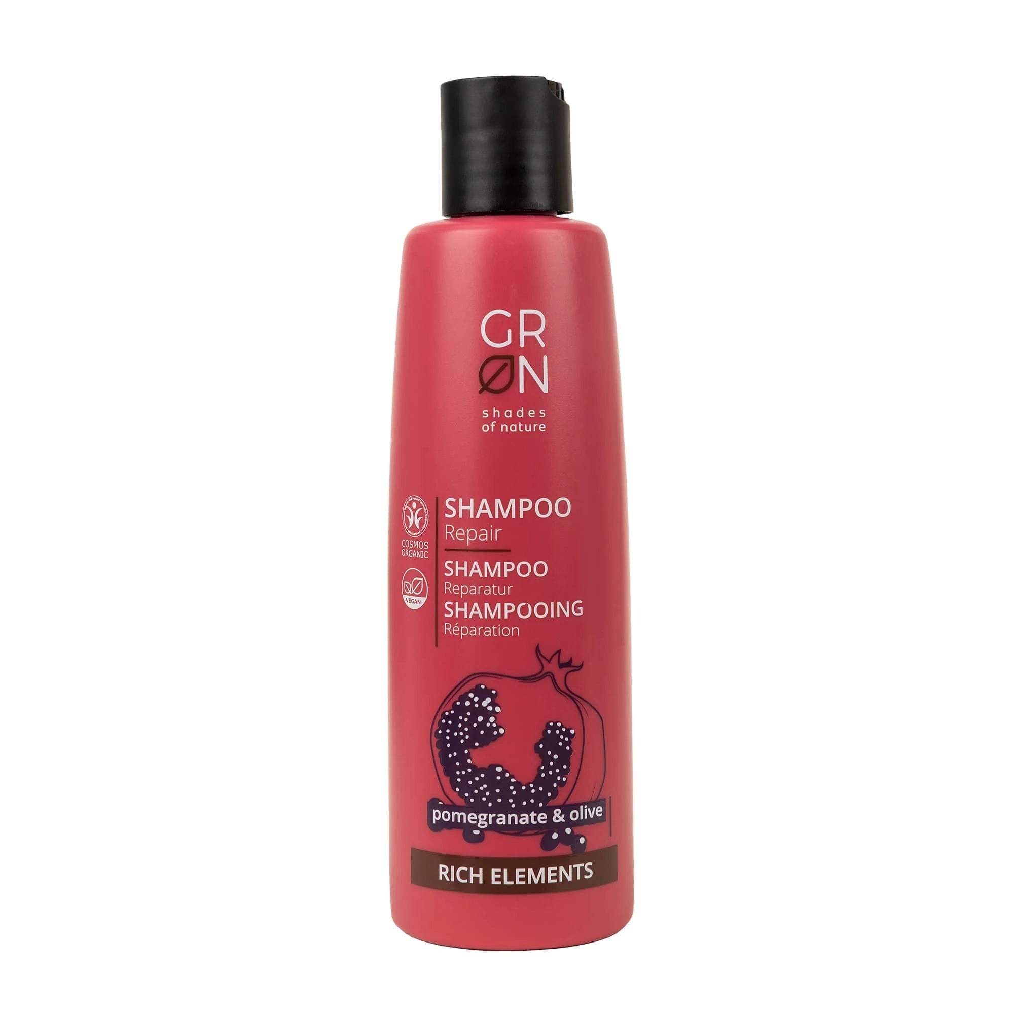 Eine rosafarbene Flasche GRØN Shampoo Repair mit Granatapfel und Olive, mit der Aufschrift Rich Elements", weißem Text und dem Umriss einer Granatapfelfrucht auf der Vorderseite.