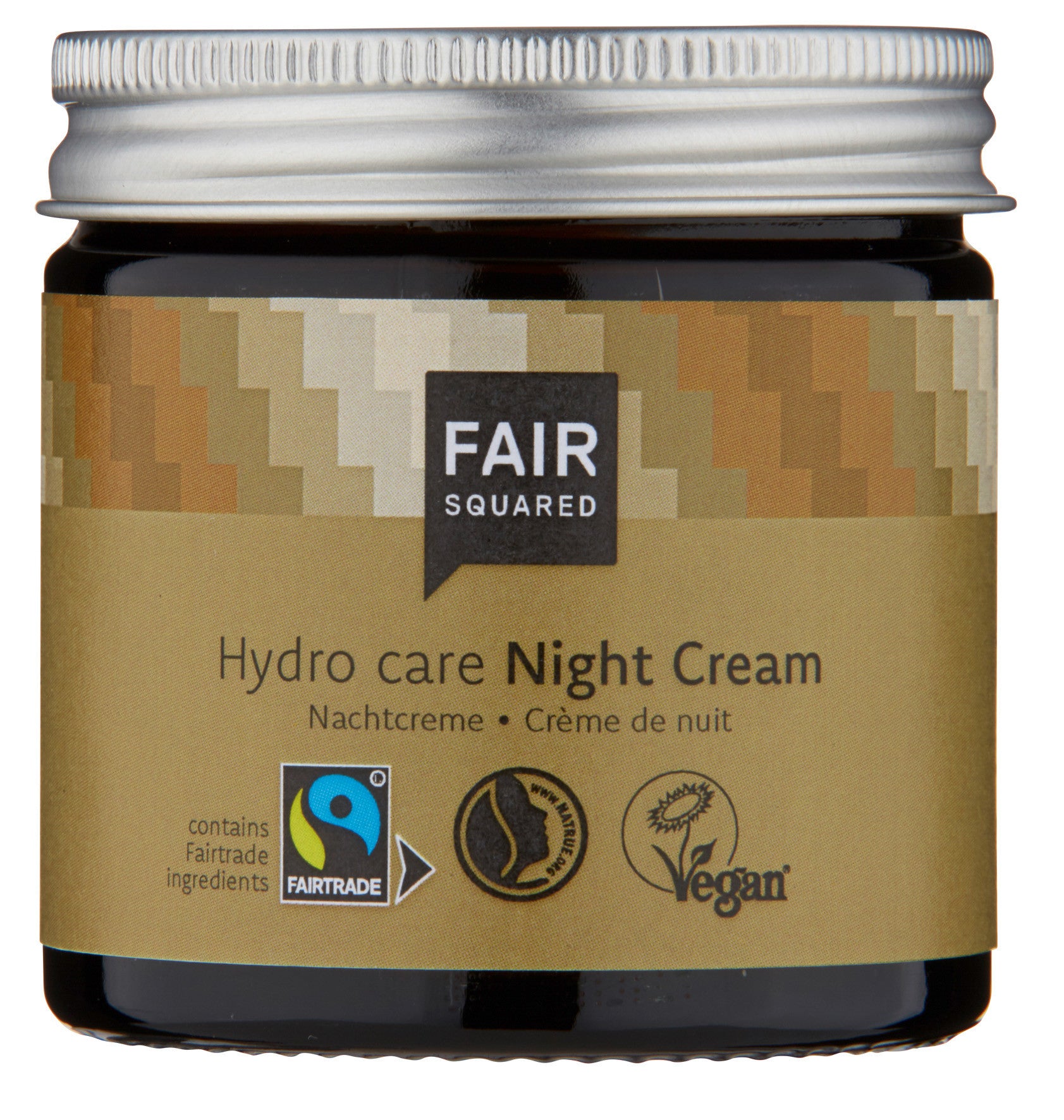 Ein Tiegel der Fair Squared Hydro Care Night Cream mit silbernem Deckel. Auf dem Etikett sind die Logos der Fairtrade- und Vegan-Zertifizierung sowie ein Text auf Englisch und Deutsch zu lesen, der die Creme als Nachtcreme mit Fairtrade-Zutaten beschreibt.