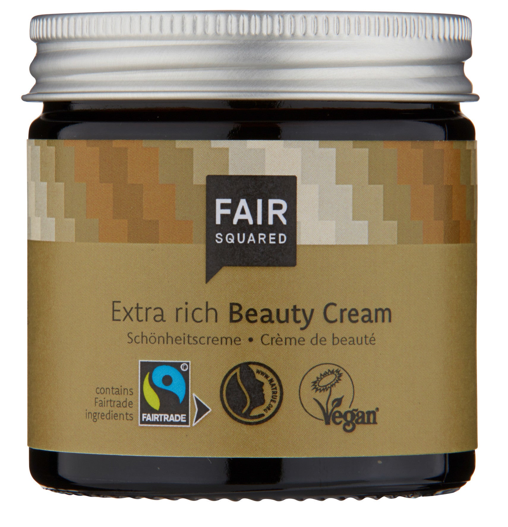 Ein Tiegel Fair Squared Extra Rich Beauty Cream mit einem goldenen Etikett, Fairtrade- und Vegan-Logos und einem silbernen Deckel. Auf dem Etikett steht auch, dass sie Fairtrade-Zutaten enthält.