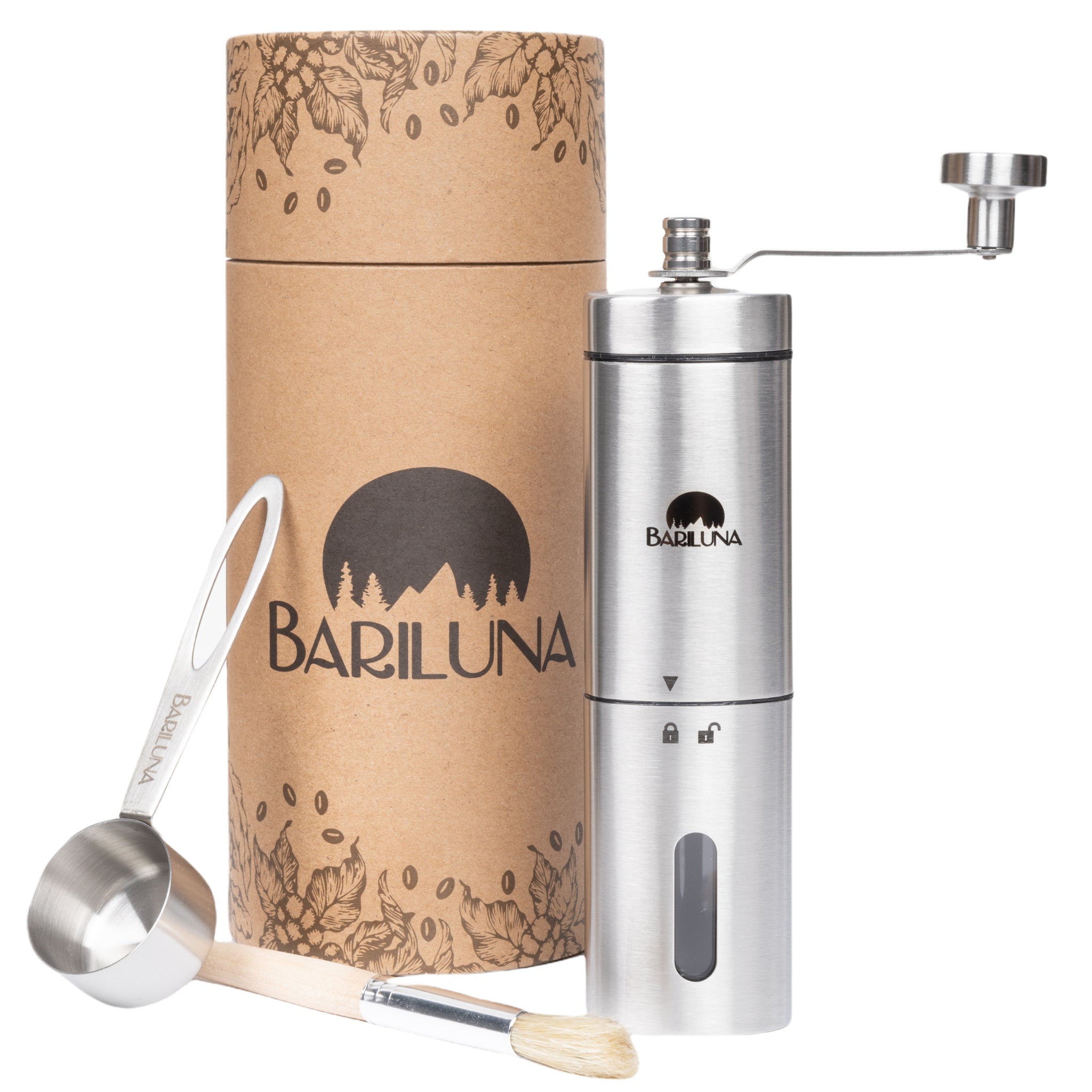 Metallene Kaffeemühle mit Handkurbel, Kaffeebürste und Messlöffel, neben einer dekorativen Verpackung mit floralem Design.