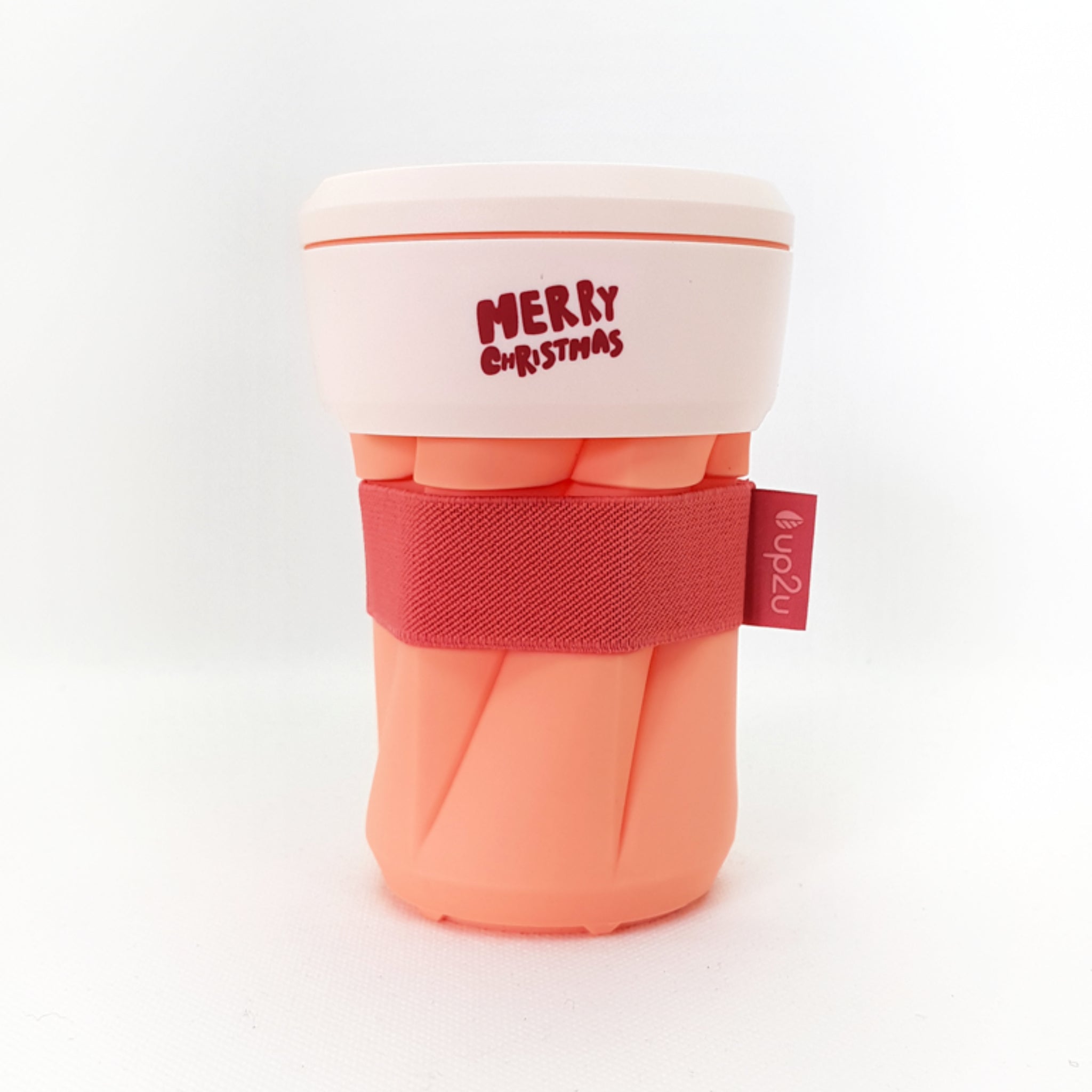 Rosa-orange Tasse mit rotem Text "Merry Christmas" auf weißem Deckel und rotem Band mit Etikett "up2u".