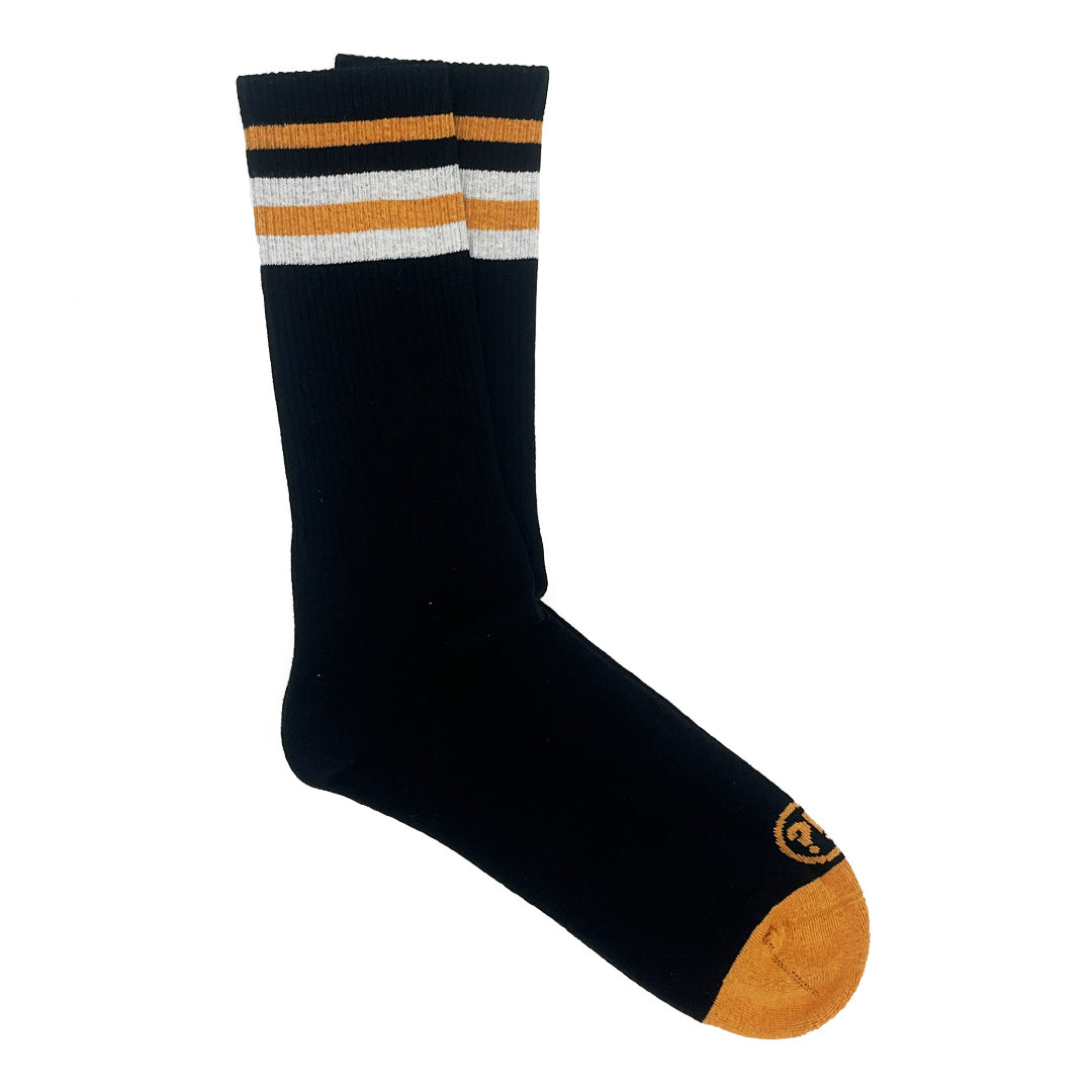 Schwarze Socken mit gelben Zehen und Streifen in Gelb, Weiß und Schwarz am Bund.