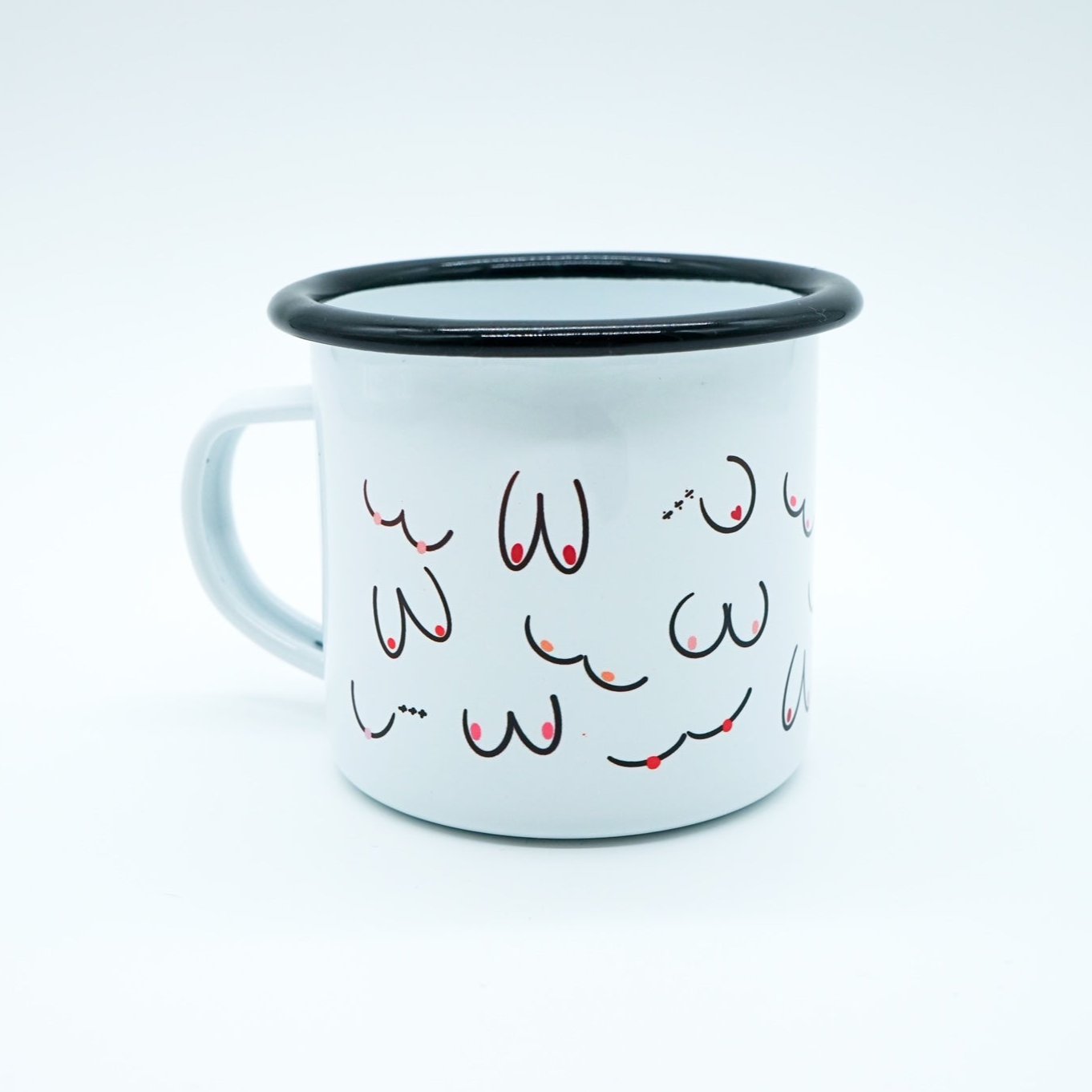 Weiße Tasse mit schwarzem Rand, dekoriert mit minimalistischen Zeichnungen von Brüsten in verschiedenen Formen und Farben.