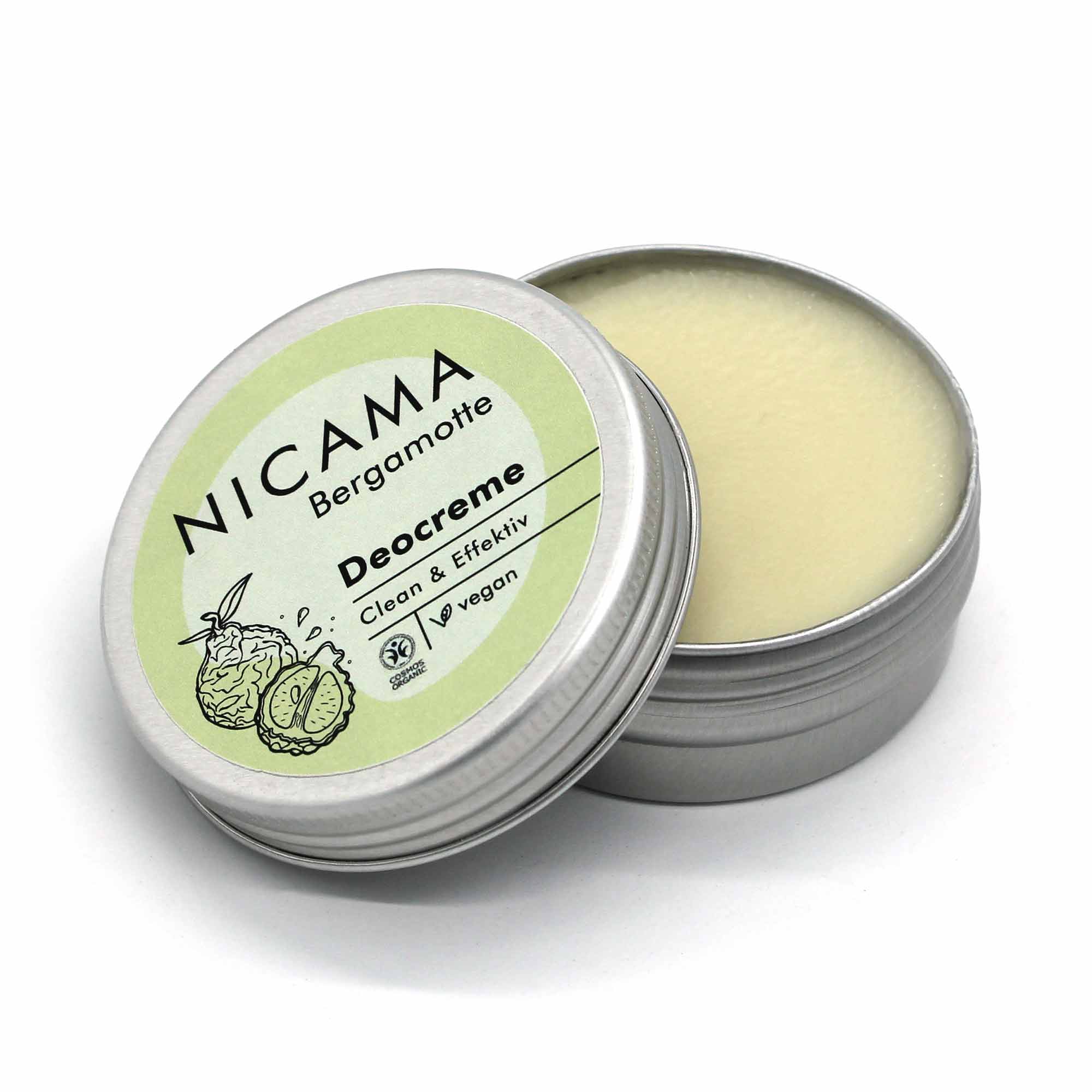 Runde Dose mit geöffneter veganer Deocreme „NICAMA Bergamotte“, grünem Etikett und Bergamotte-Illustration.