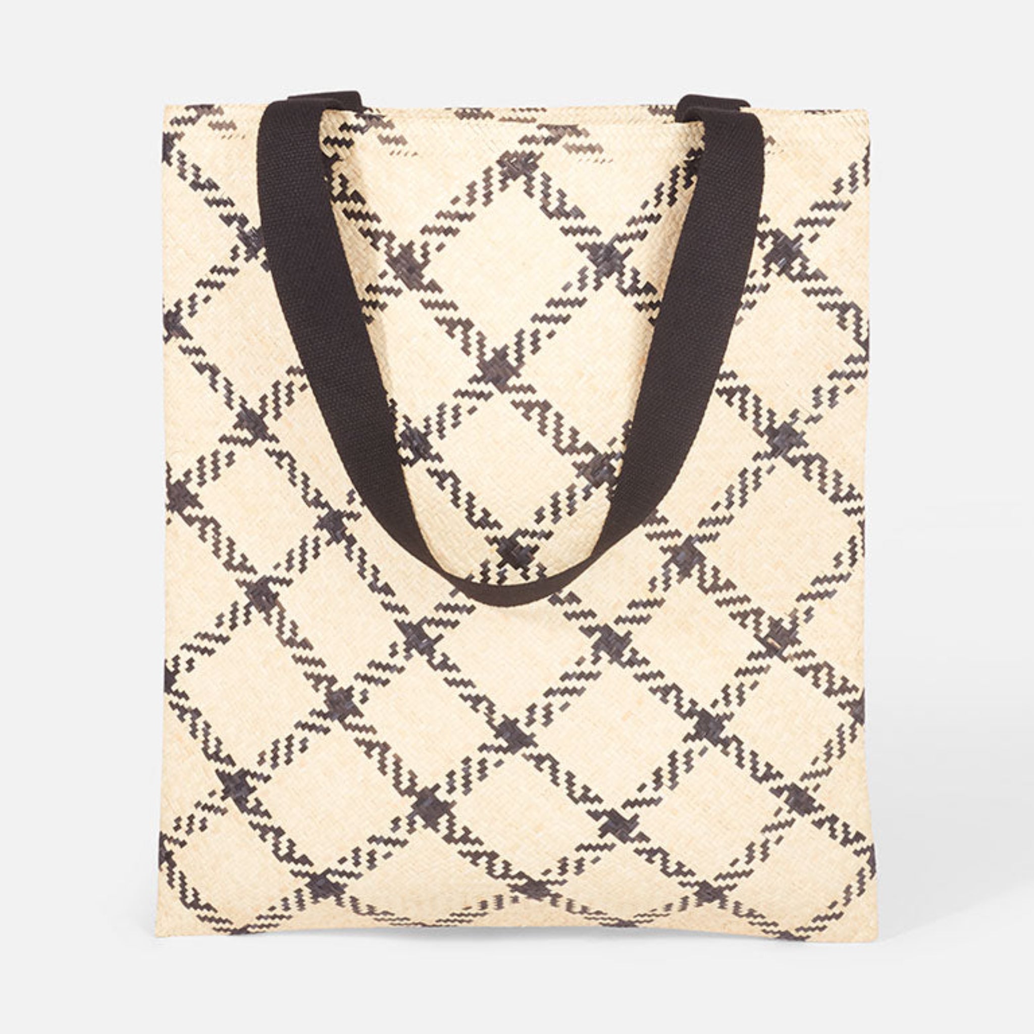 Beige Stofftasche mit schwarzen, rautenförmigen Mustern und schwarzen Tragegriffen auf hellem Hintergrund.