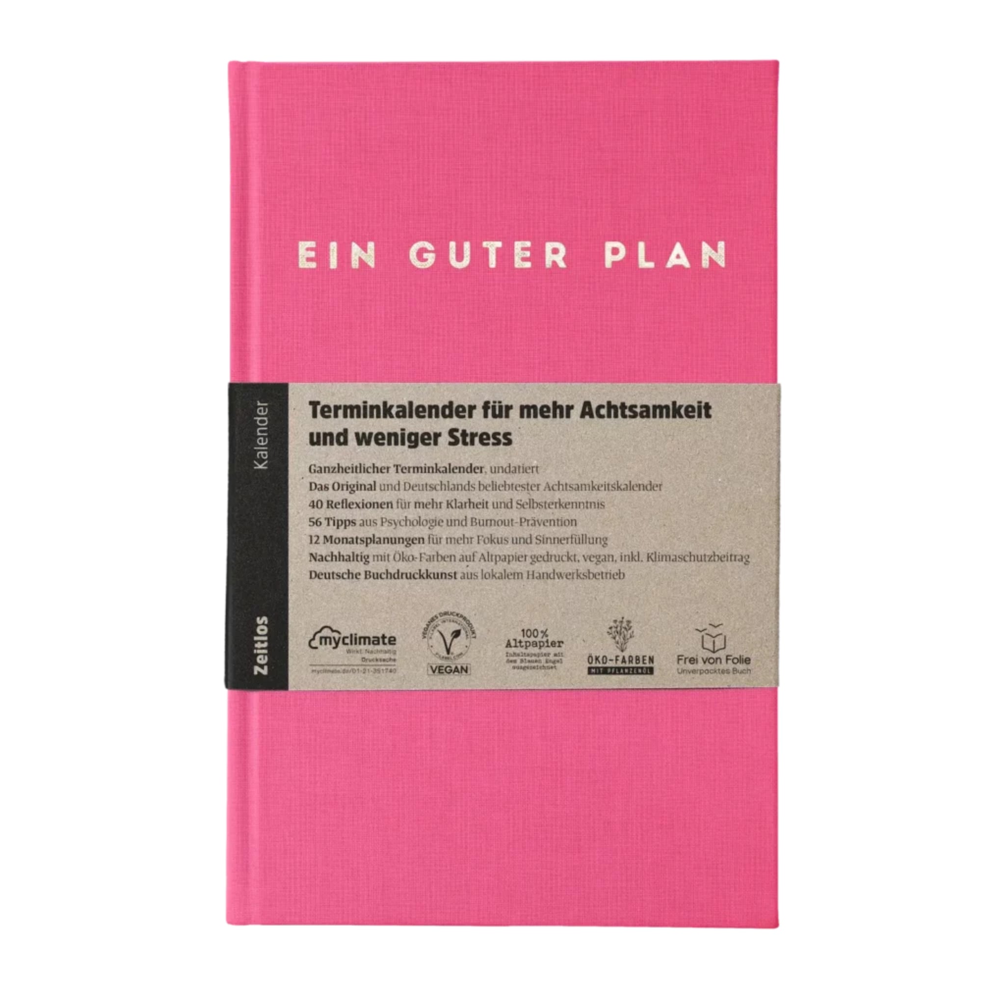 Pinkfarbener Terminplaner "Ein Guter Plan" mit Papierbanderole, die Informationen zur Nutzung und Nachhaltigkeit enthält.