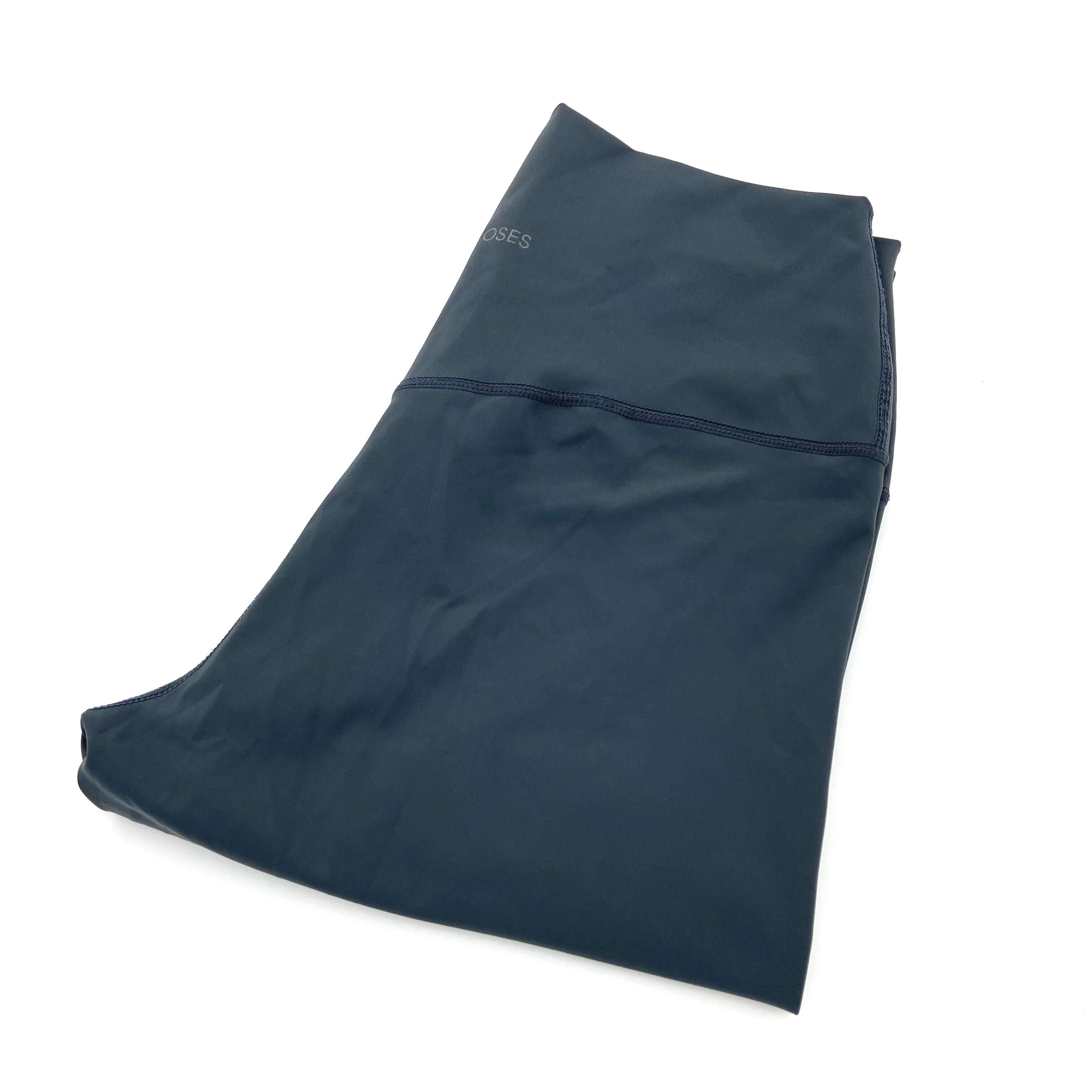 Dunkelblaue, gefaltete Hose aus Stoff auf weißem Hintergrund.