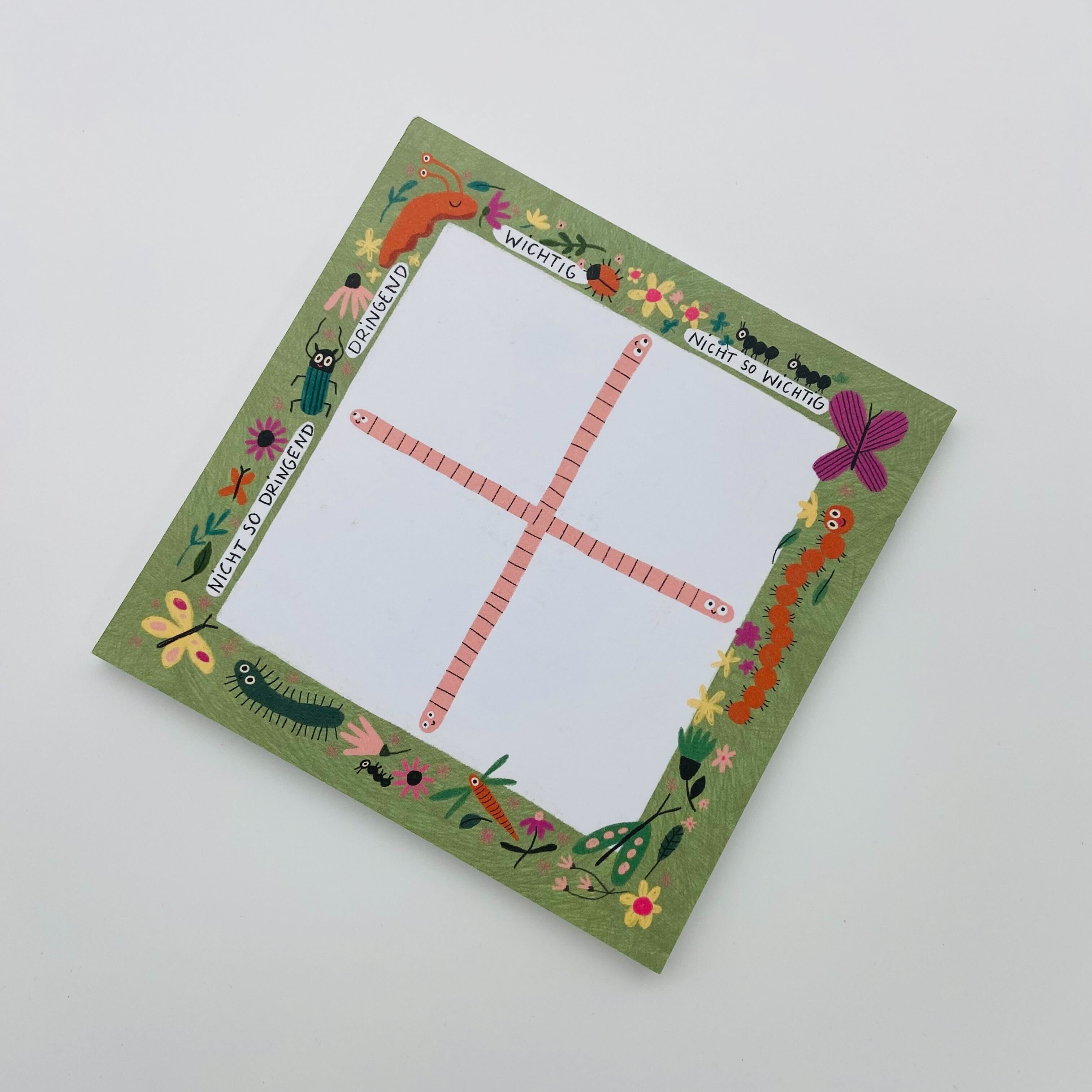 Quadratischer Notizblock mit Prioritätsmatrix, umgeben von Blumen und Tieren, mit Kategorien wie "Wichtig" und "Dringend".