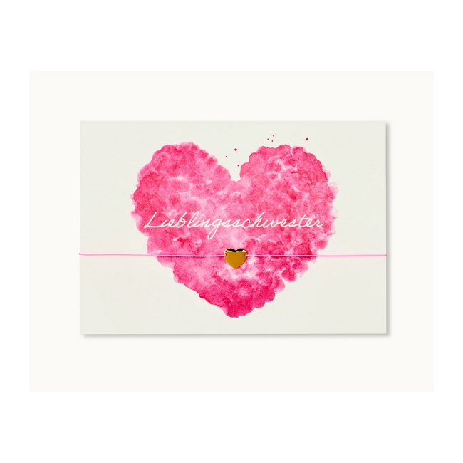Eine Karte mit einem rosa Herz und der Aufschrift "Lieblingsschwester", verziert mit einem kleinen goldenen Herz.