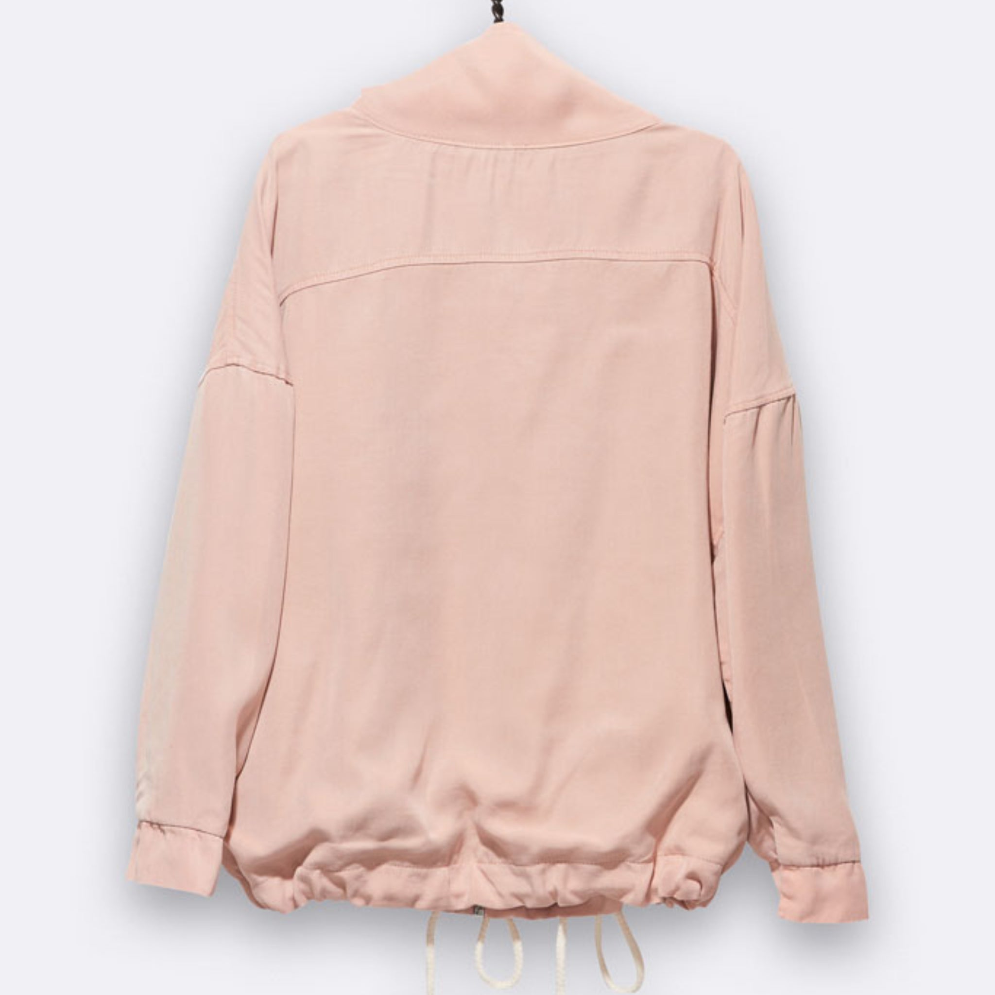 Eine hellrosa langärmelige Jacke wird auf einem Kleiderbügel ausgestellt, von hinten gesehen. Die Jacke hat eine lockere Passform, überschnittene Schultern und einen verstellbaren Kordelzug am unteren Saum.