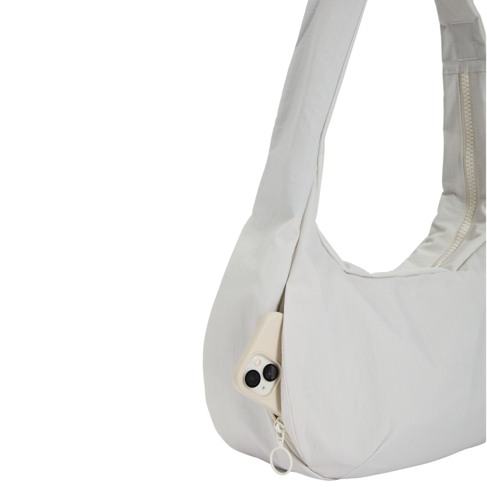 Weiße Umhängetasche mit Reißverschluss, aus der eine helle Kamera herausragt.