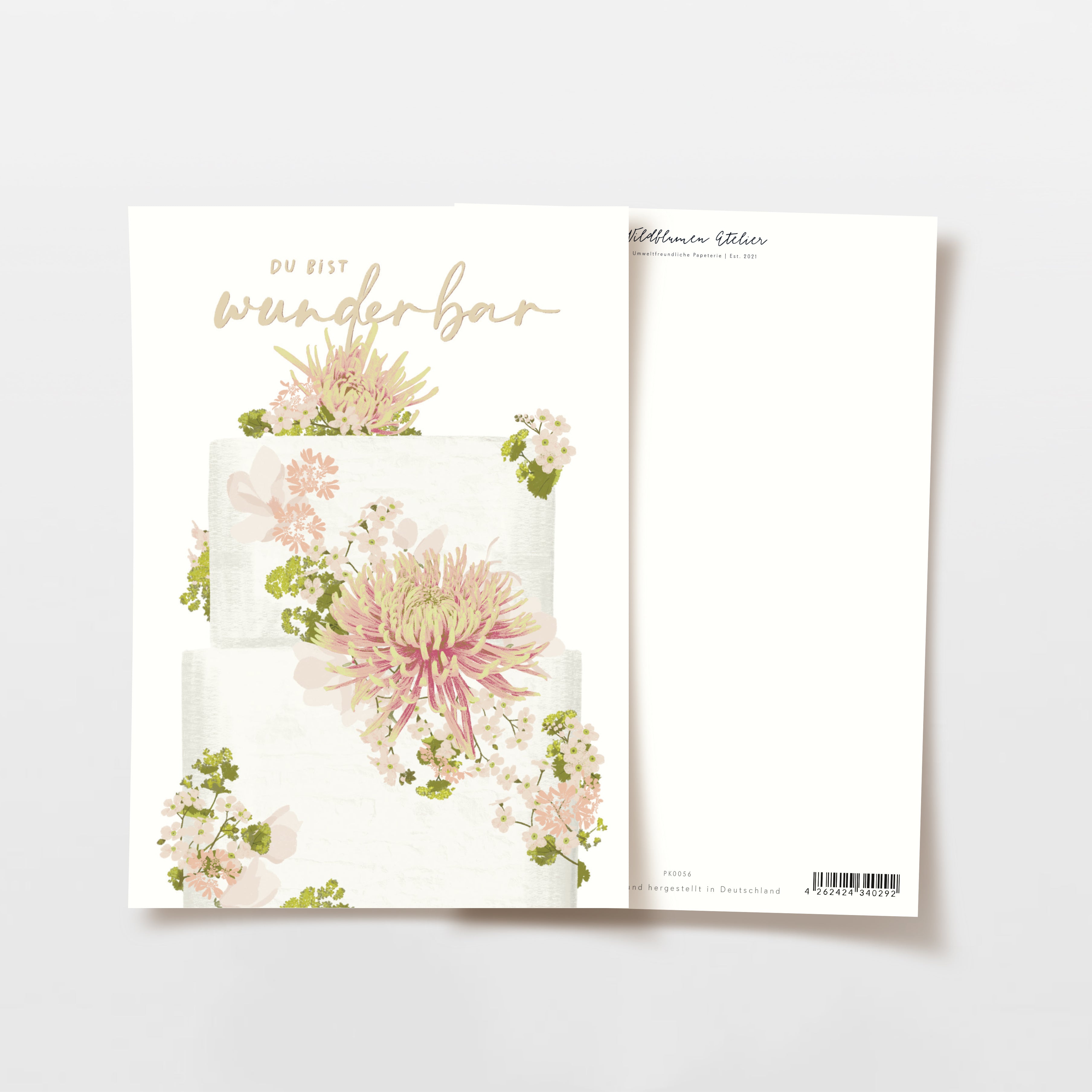 Karte mit dem Text "Du bist wunderbar" und einem Blumenmuster auf einem zweistöckigen Kuchen.