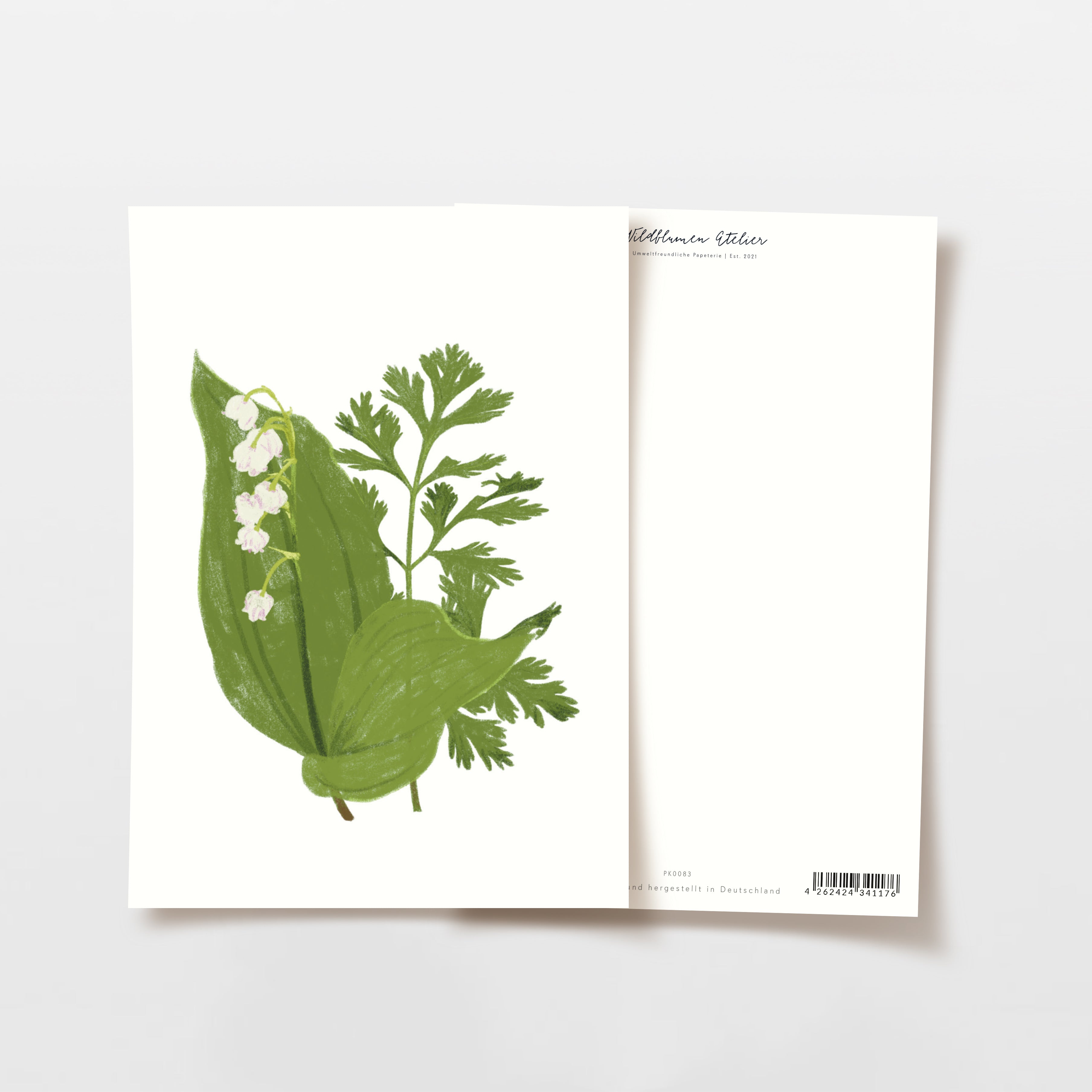 Illustration von grünen Blättern und Maiglöckchenblüten auf einer weißen Karte vor einem leeren Hintergrund.