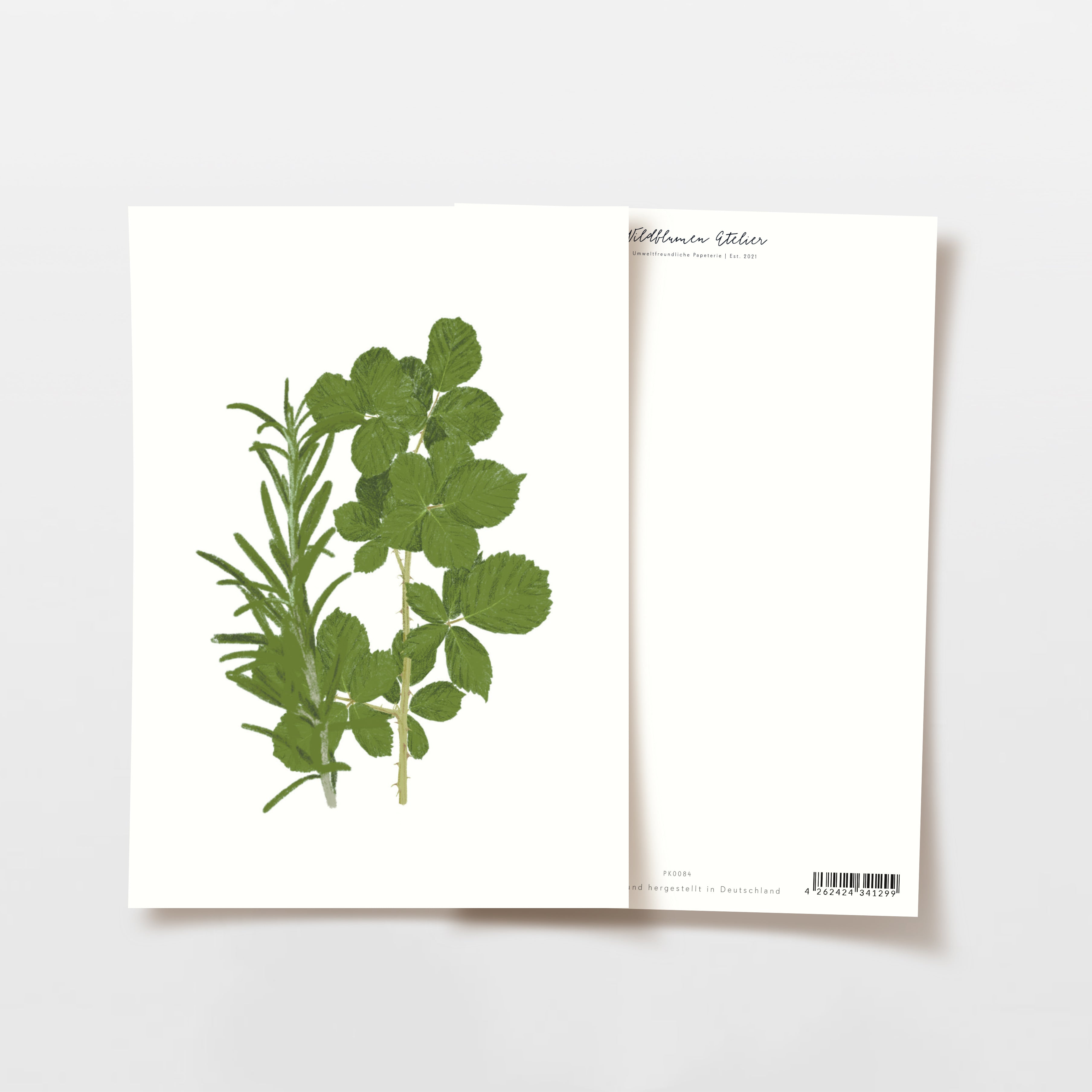 Zwei Papierblätter, eines mit einem grünen Kräuteraufdruck, das andere auf der Rückseite mit einem Barcode.