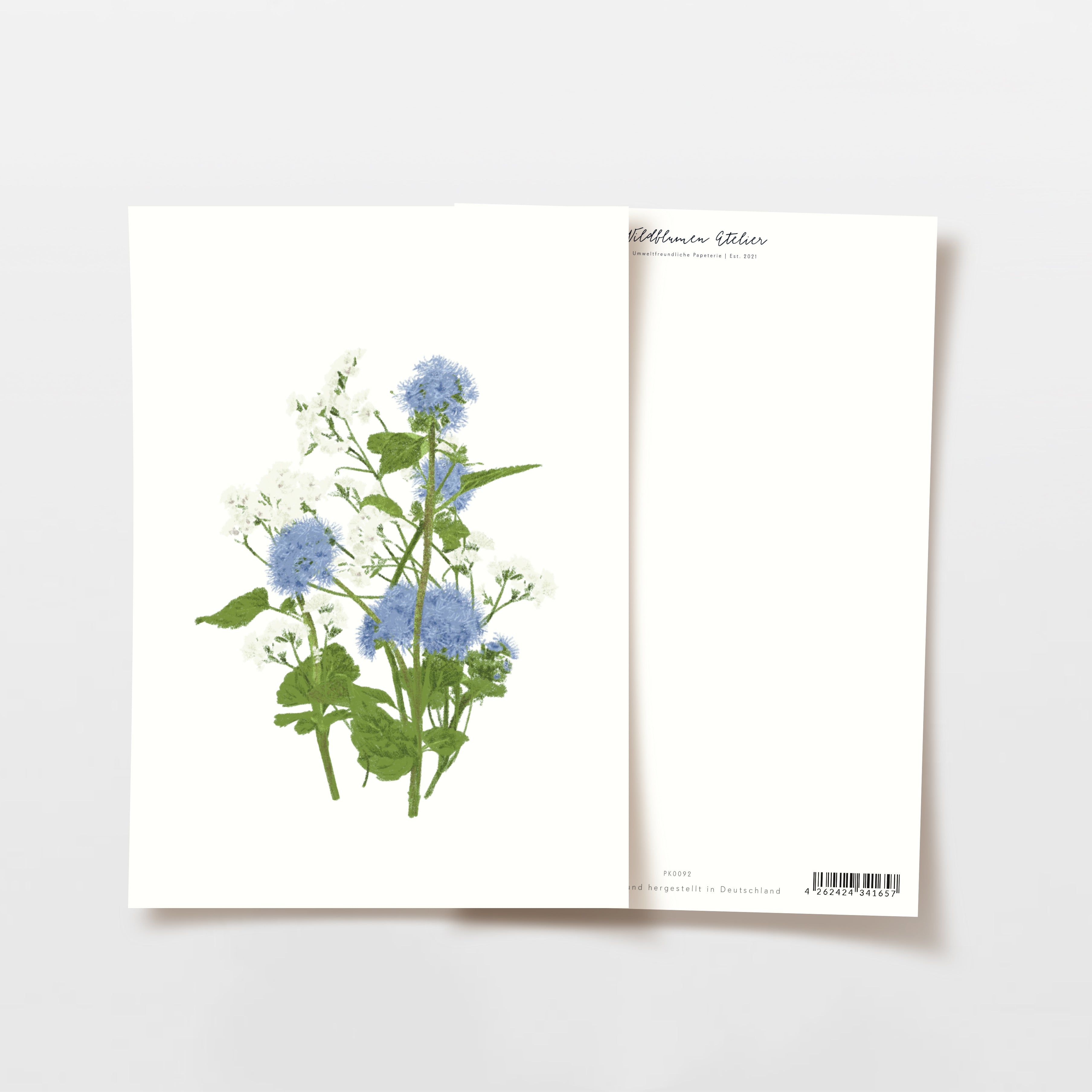 Zwei Karten sind abgebildet, eine zeigt ein Bouquet aus blauen und weißen Blumen, die andere ist schlicht.
