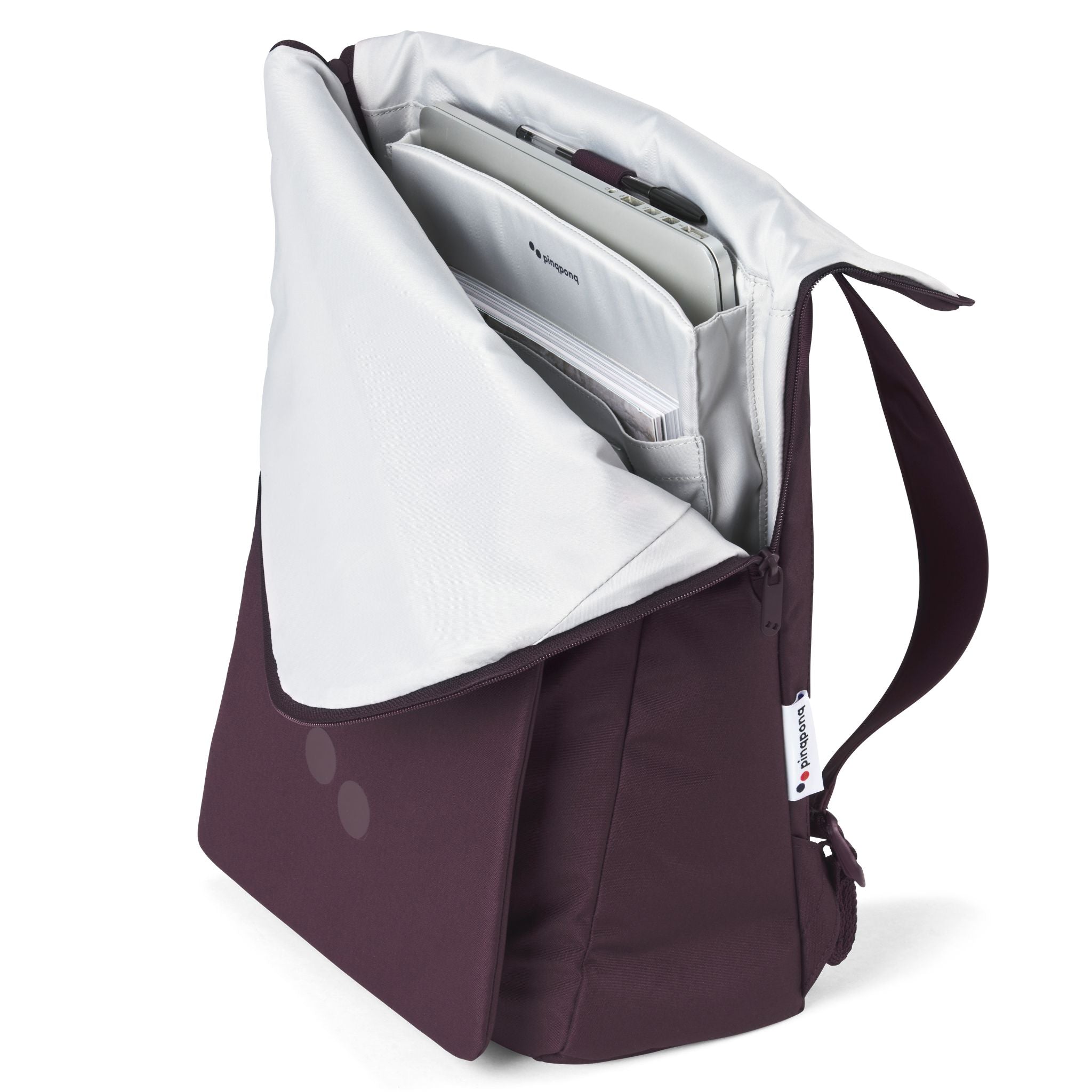 Geöffnete lila Umhängetasche mit Laptop und Dokumenten im Inneren.