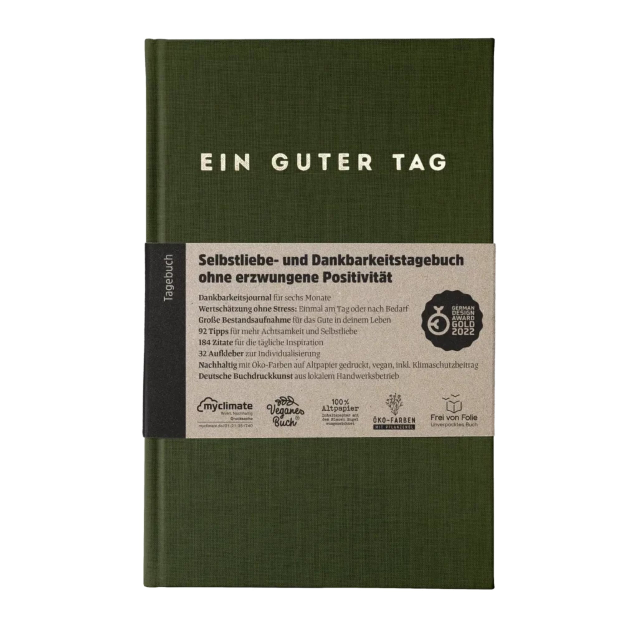 Grünes Tagebuch mit der Aufschrift "EIN GUTER TAG" und Informationen zur Selbstliebe und Dankbarkeit auf dem Einband.