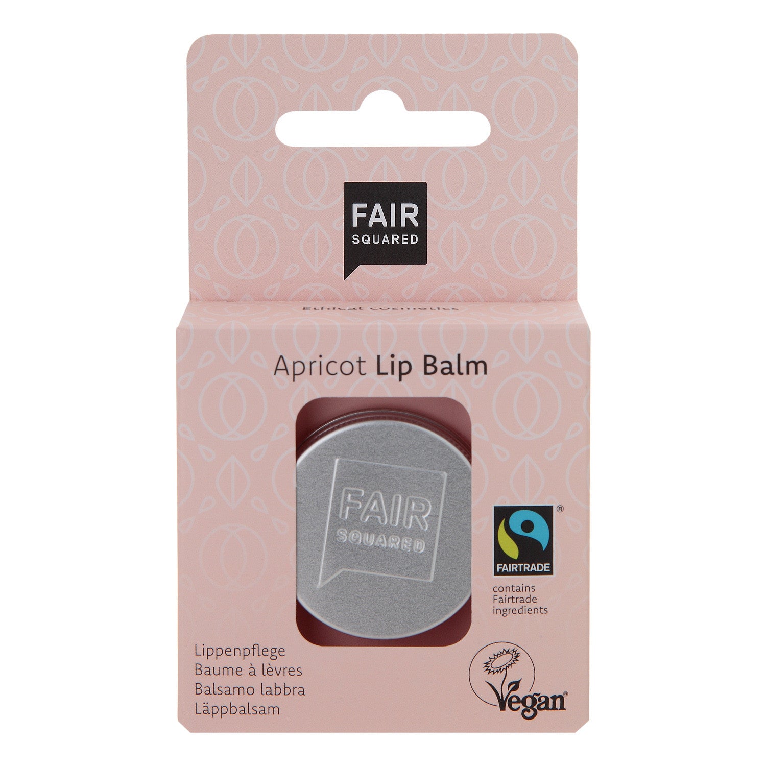 Eine Schachtel mit Fair Squared Apricot Lip Balm in einer Metalldose. Die Verpackung ist rosa, Fairtrade und Vegan, und zeigt Produktinformationen in mehreren Sprachen.