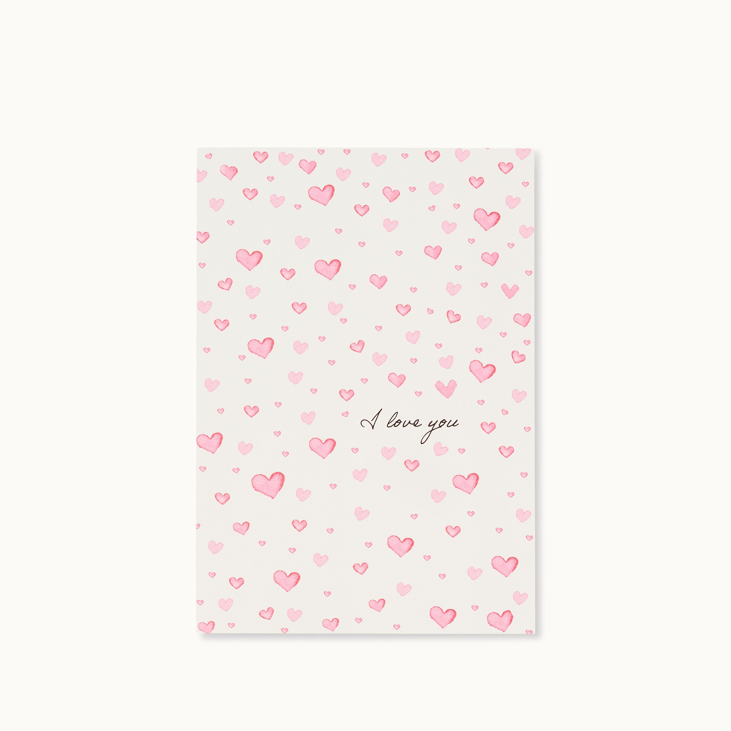 Karte mit rosa Herzen und der Aufschrift "I love you" auf weißem Hintergrund.