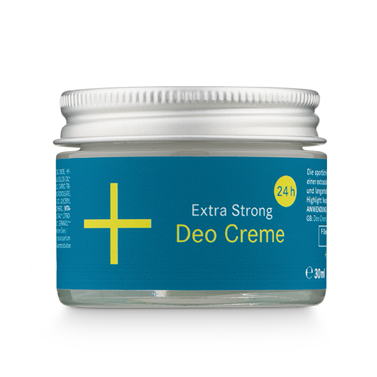 Kleiner Glastiegel mit silbernem Deckel und der Aufschrift Extra Strong Deo Creme 24h in gelber und weißer Schrift auf blauem Grund, mit einem gelben Pluszeichen auf der linken Seite. Der Tiegel enthält 30 ml des Produkts.