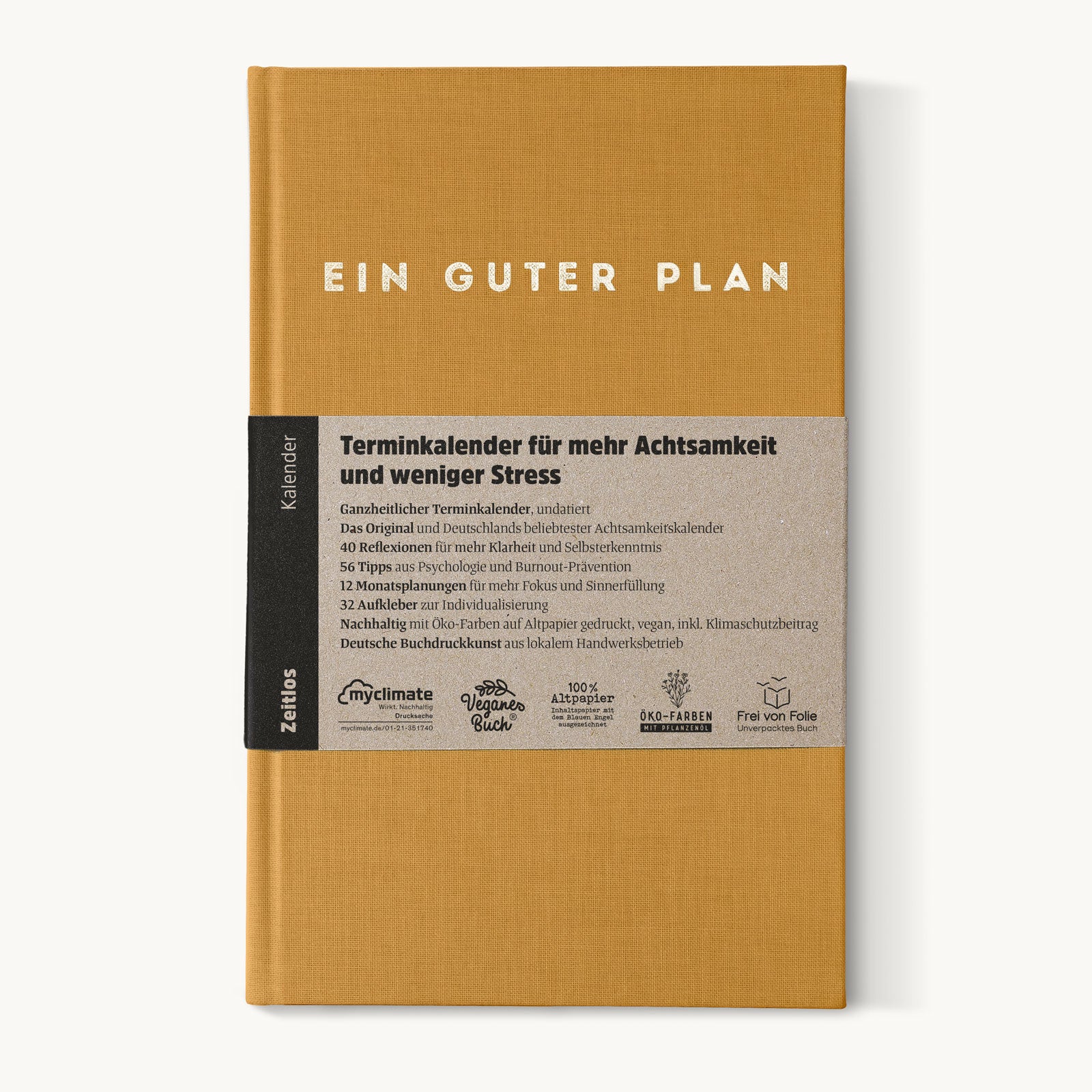 Orangefarbener Kalender mit Aufschrift "EIN GUTER PLAN" und Banderole mit Details zum Achtsamkeitskalender.