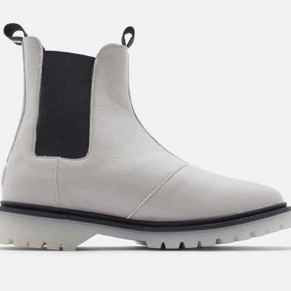 Weiße Chelsea-Stiefel mit schwarzem Elastikeinsatz und Profilsohle, seitlich aufgenommen.