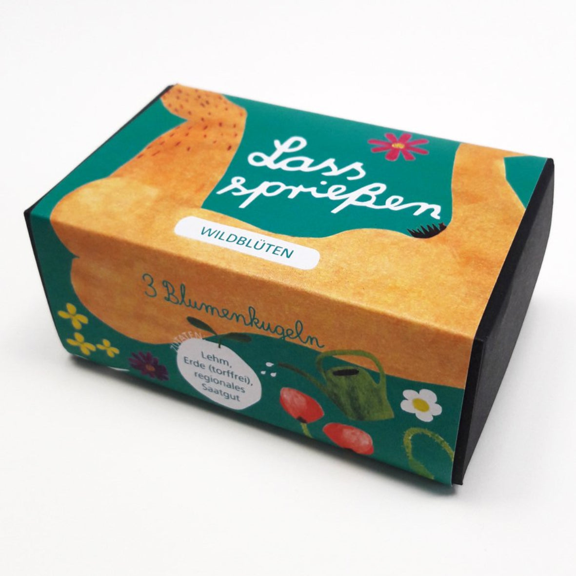 Eine farbenfrohe rechteckige Seifendose mit deutschem Text, der "Lass sprießen", "Wildblüten" und "3 Blumenbälle" lautet. Das Design zeigt Blumen, Pflanzen und eine illustrierte Form in Orange- und Grüntönen.