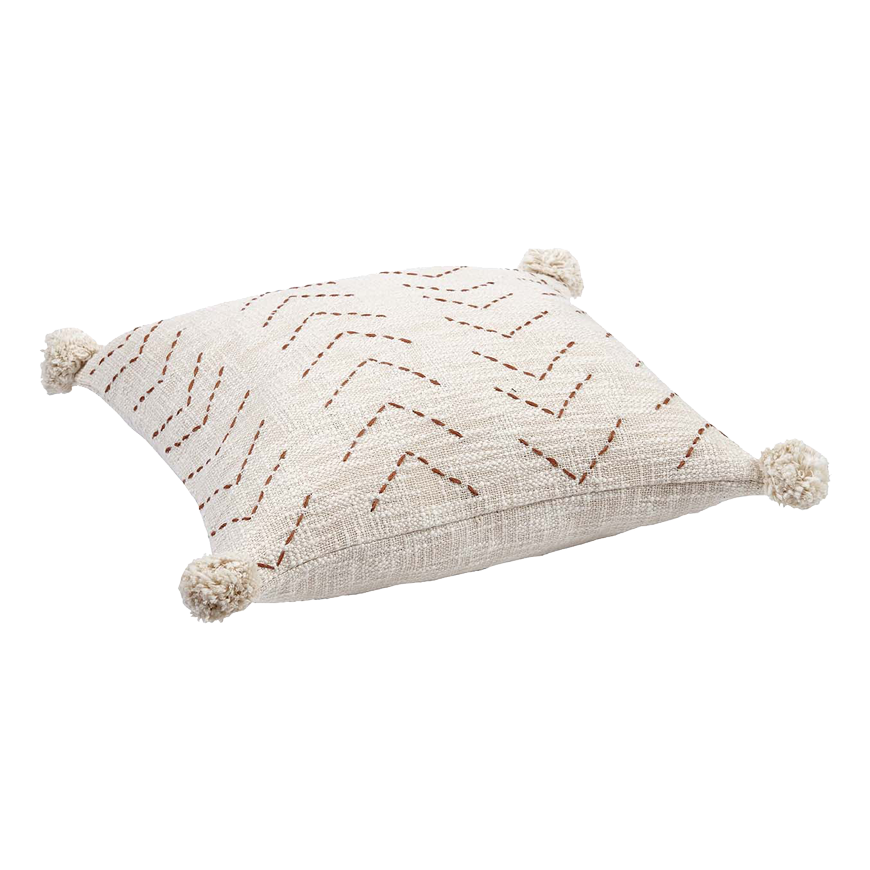 Beiger Kissenbezug mit Zickzack-Muster und Quasten an den Ecken.