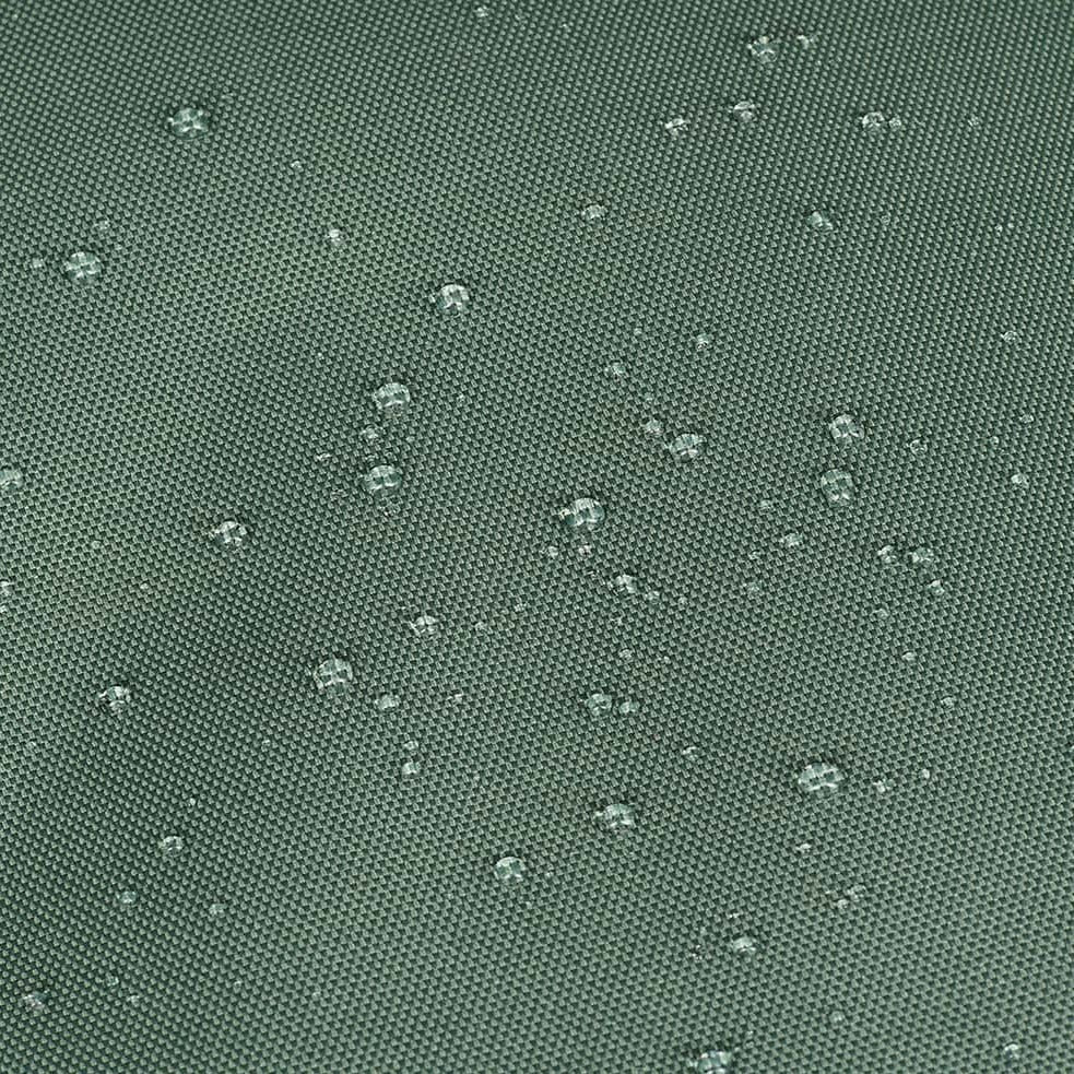 Wassertropfen auf einer grünen wasserabweisenden Stoffoberfläche.