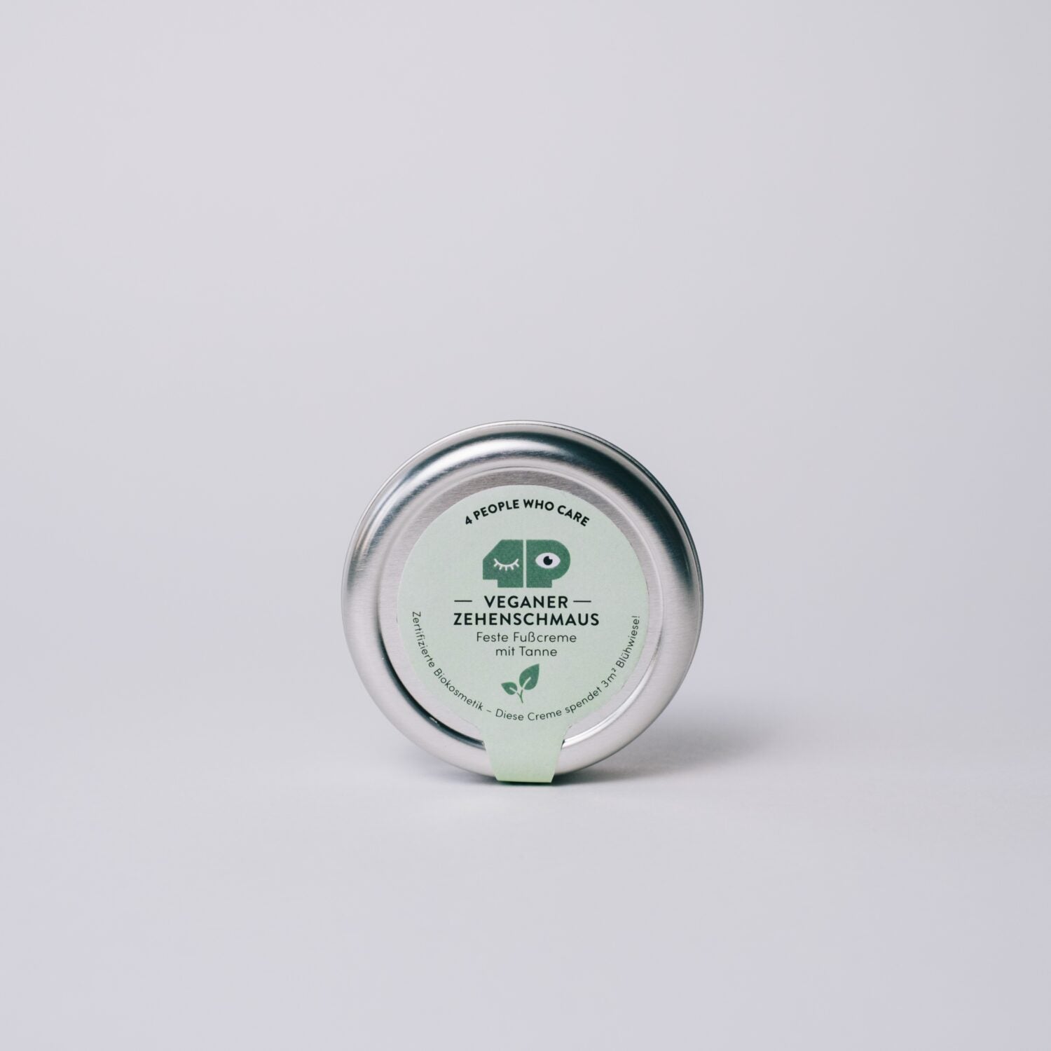 Runde Dose mit grünem Etikett, das "Veganer Zehenschmaus" und weitere Details anzeigt.