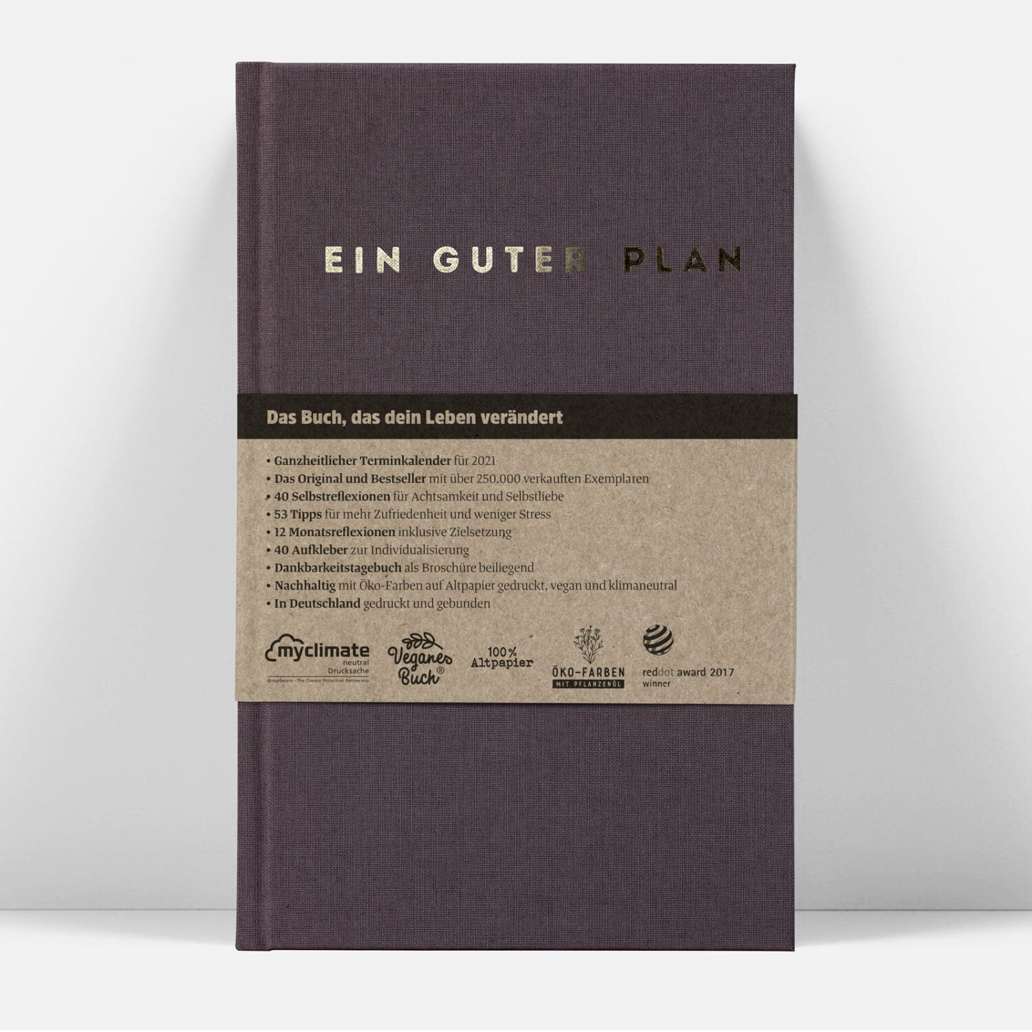 Kalenderbuch mit dem Titel „Ein Guter Plan“, brauner Umschlag, Beschreibung und Nachhaltigkeitssiegel auf dem Cover.