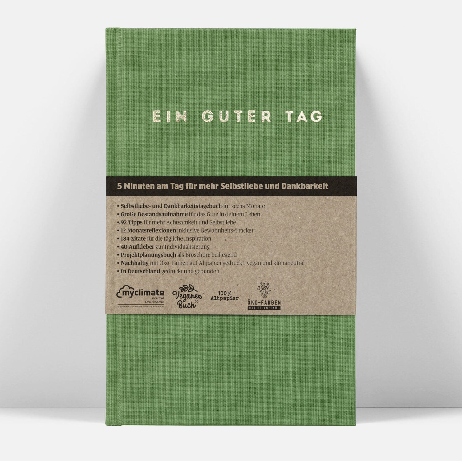 Grünes Buch mit Titel "Ein guter Tag" und Untertitel über Selbstliebe und Dankbarkeit. Enthält ökologische Hinweise.