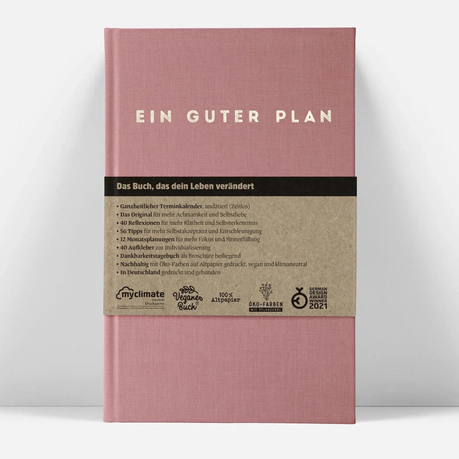 Rosa Buchcover mit der Aufschrift "Ein Guter Plan" und Text über die Inhalte des Buches auf einem braunen Streifen.