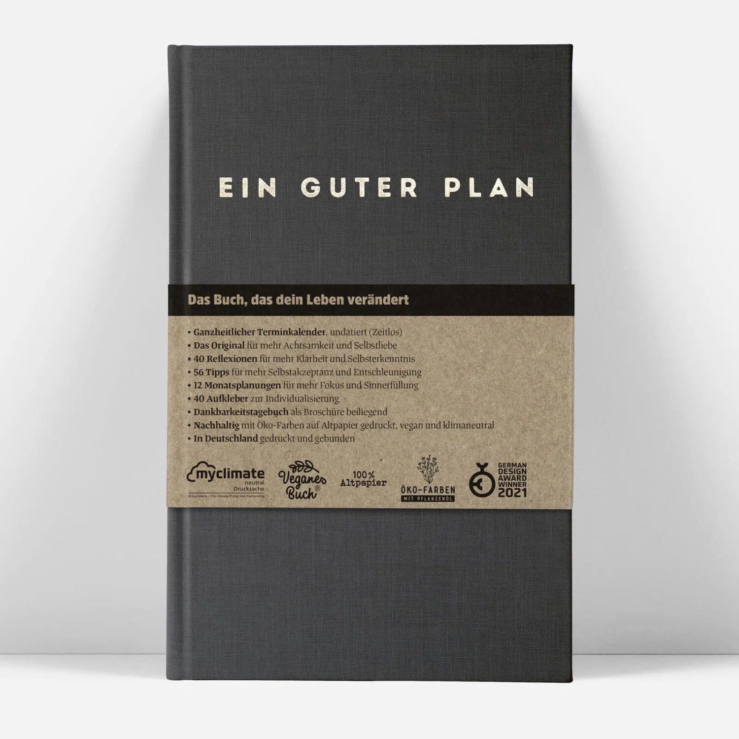 Ein dunkles Buchcover mit dem Titel "Ein Guter Plan" und einer braunen Banderole mit Details zum Inhalt.