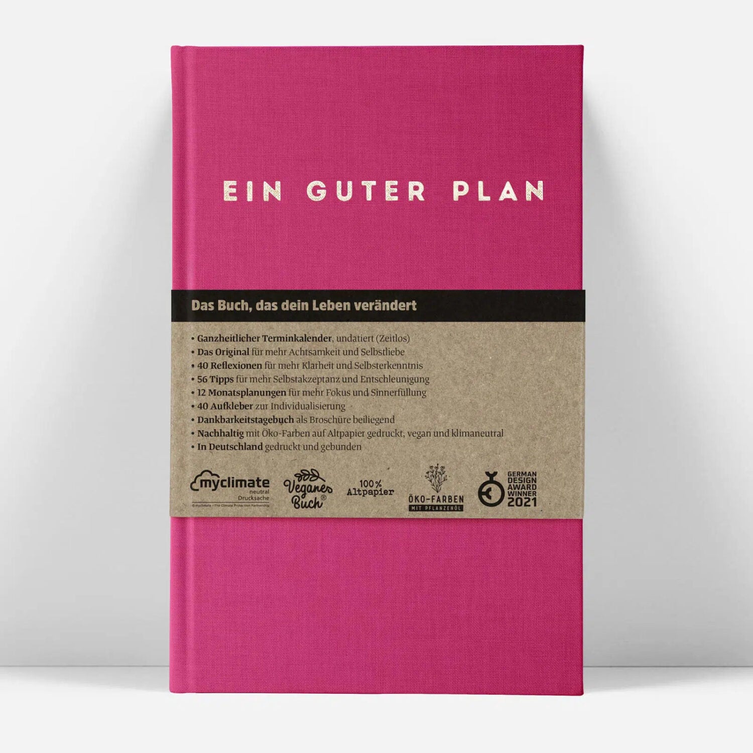 Pinkes Buch mit dem Titel "Ein Guter Plan" und einer Beschreibung, die Details zum Inhalt und zur nachhaltigen Herstellung bietet.