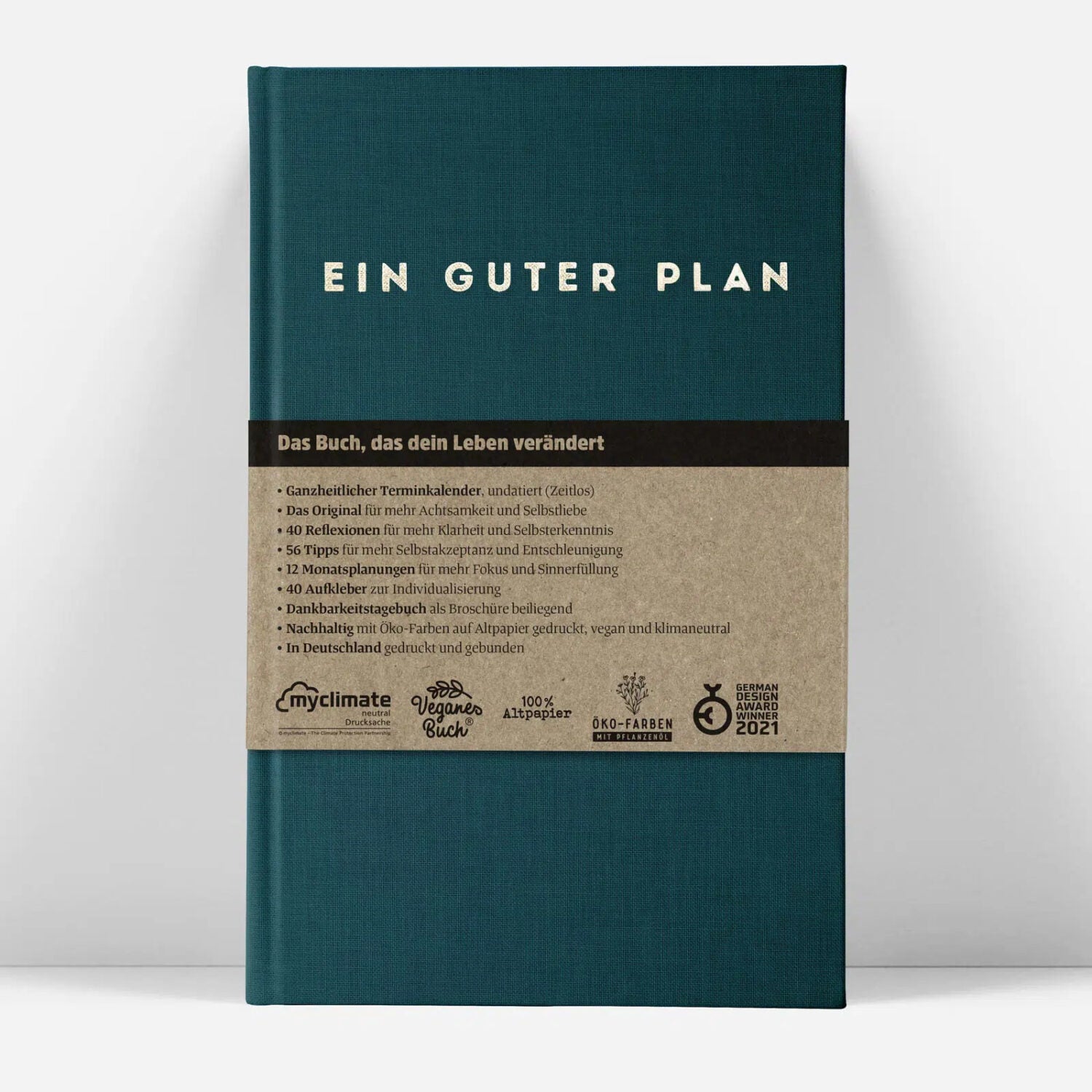 Blaues Buch mit dem Titel „Ein Guter Plan“ und einer Broschüre, die Vorzüge und Merkmale des Kalenders beschreibt.
