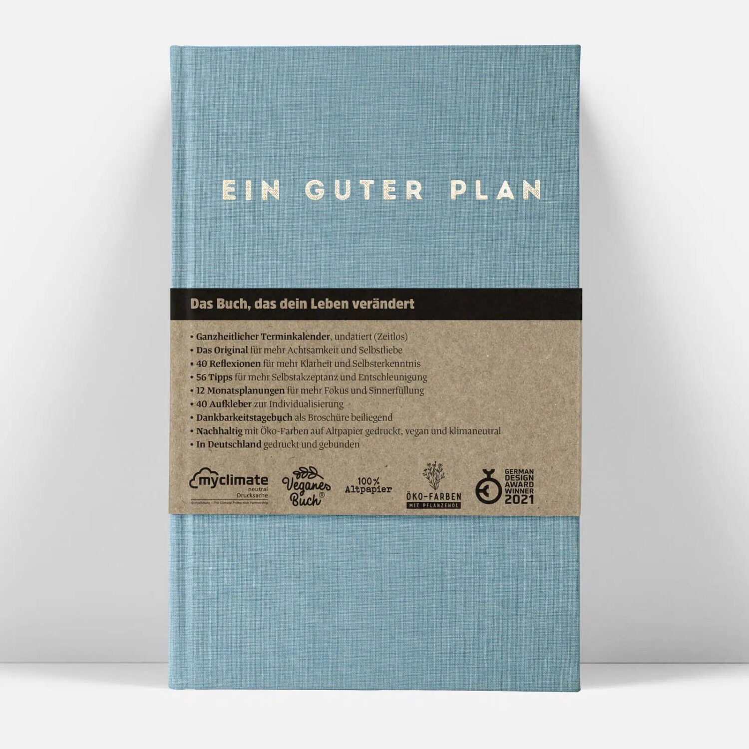 Blauer Kalender mit der Aufschrift "Ein Guter Plan" und Beschreibung eines achtsamen Planungsbuchs darunter.