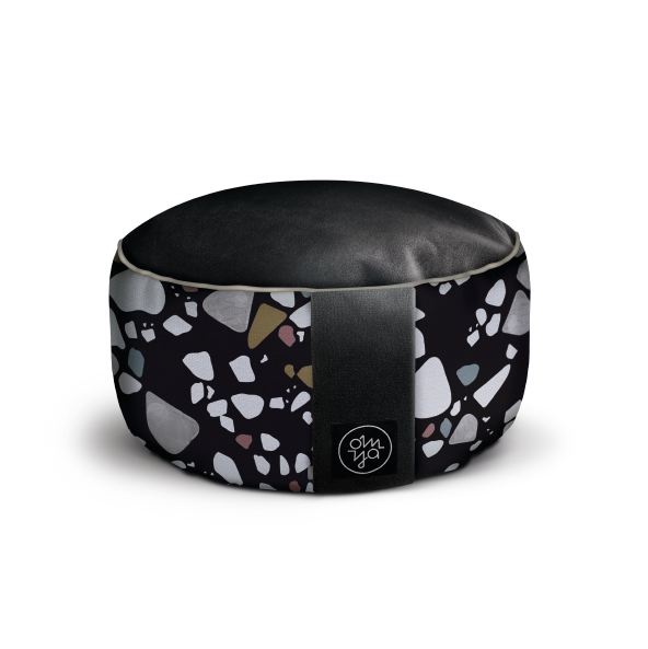 Runder Sitzpouf mit schwarzem Oberteil und buntem Muster auf dunklem Hintergrund, verziert mit einem Logo auf der Seite.