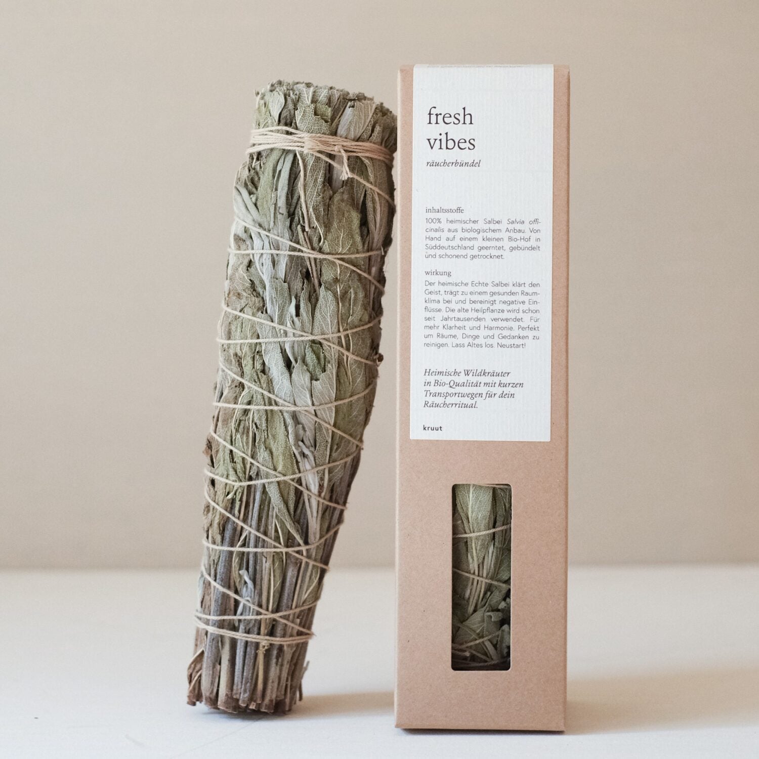 Ein Bündel getrockneter Salbei, umwickelt mit Schnur, neben einer Verpackung mit der Aufschrift "fresh vibes".