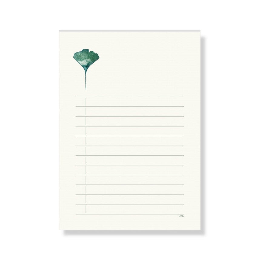 Linierte Notizseite mit grünem Ginkgoblatt im oberen linken Bereich.