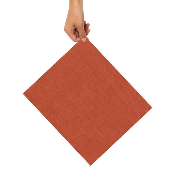 Eine Hand hält eine quadratische, orangefarbene Serviette gegen einen weißen Hintergrund.