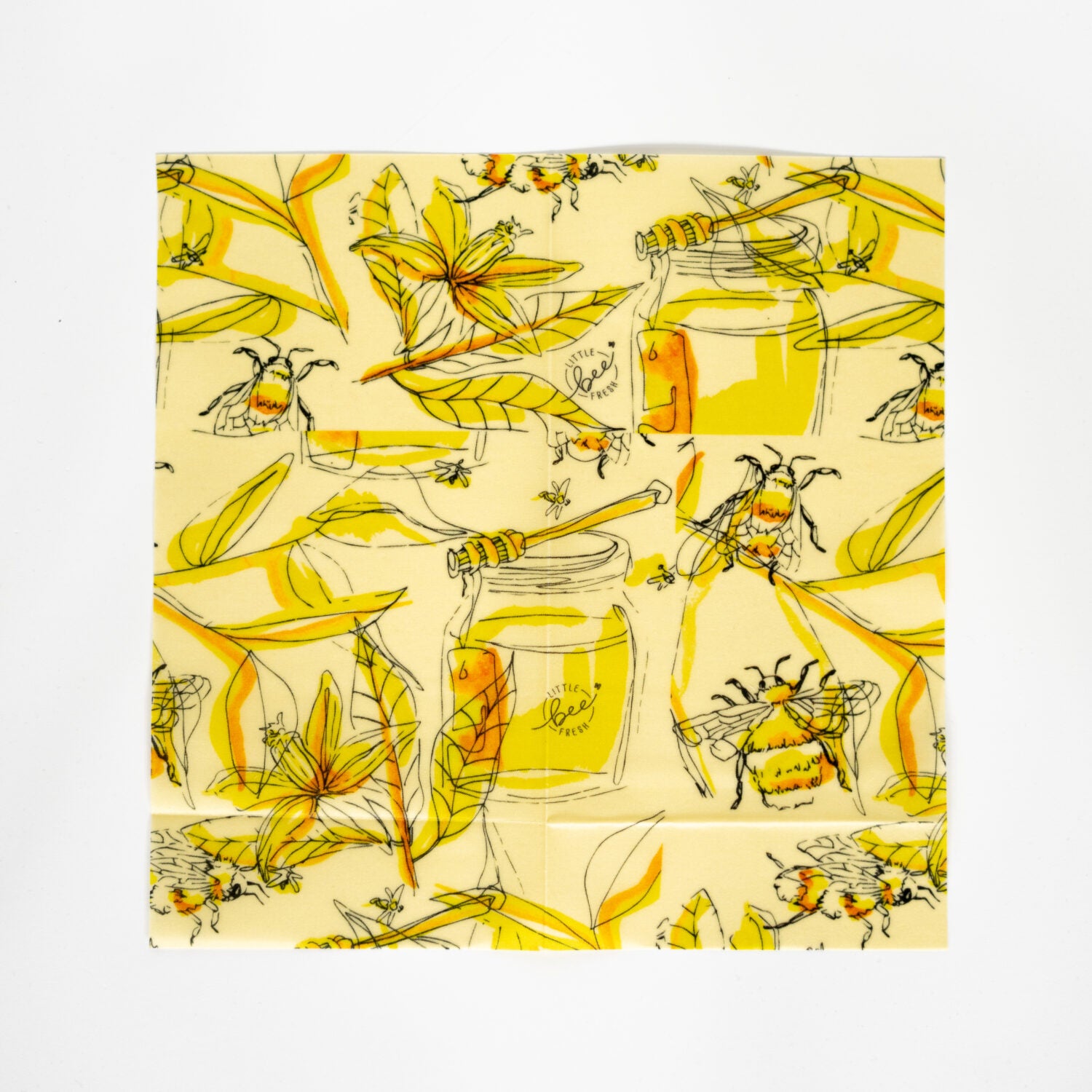 Wiederverwendbares Wachstuch mit gelbem und grünem Muster von Bienen, Blättern und Honiggläsern auf beigem Hintergrund.