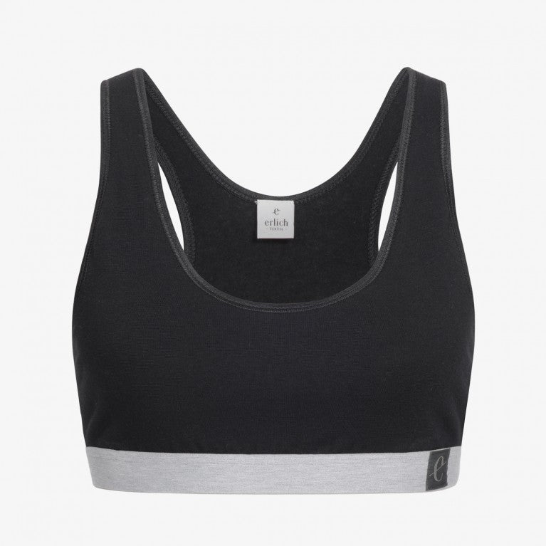 Schwarzer Sport-BH mit grauem Unterband und "erlich"-Etikett auf der Innenseite, vor weißem Hintergrund.