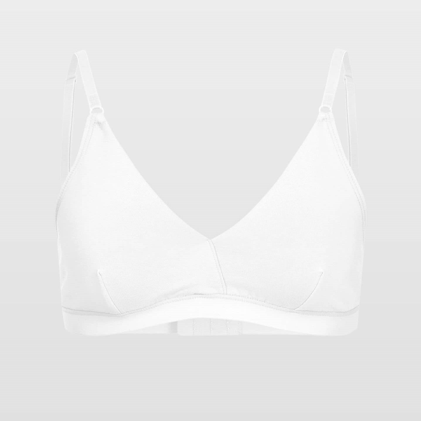 Weißer, minimalistischer Damen-BH mit schmalen verstellbaren Trägern vor grauem Hintergrund.