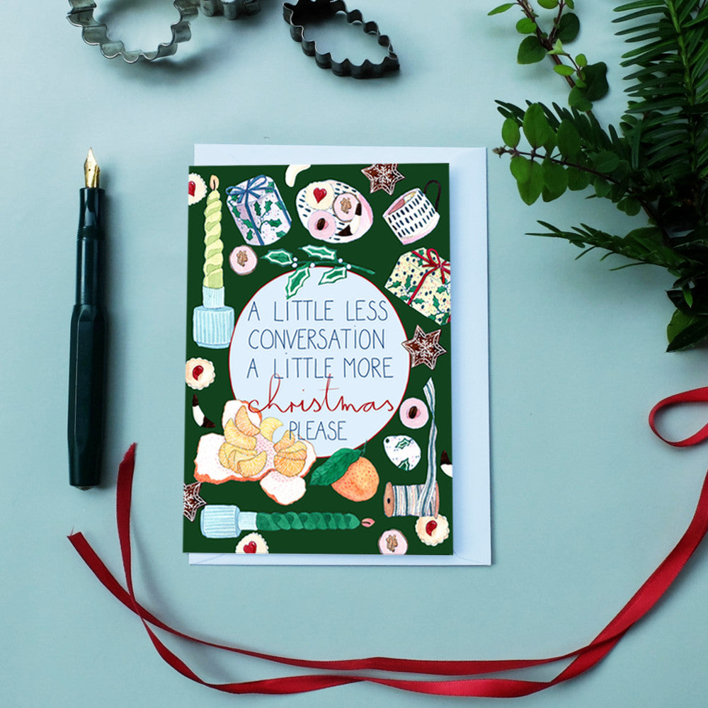Karte mit Weihnachtssymbolen und dem Text: "A little less conversation a little more Christmas please".