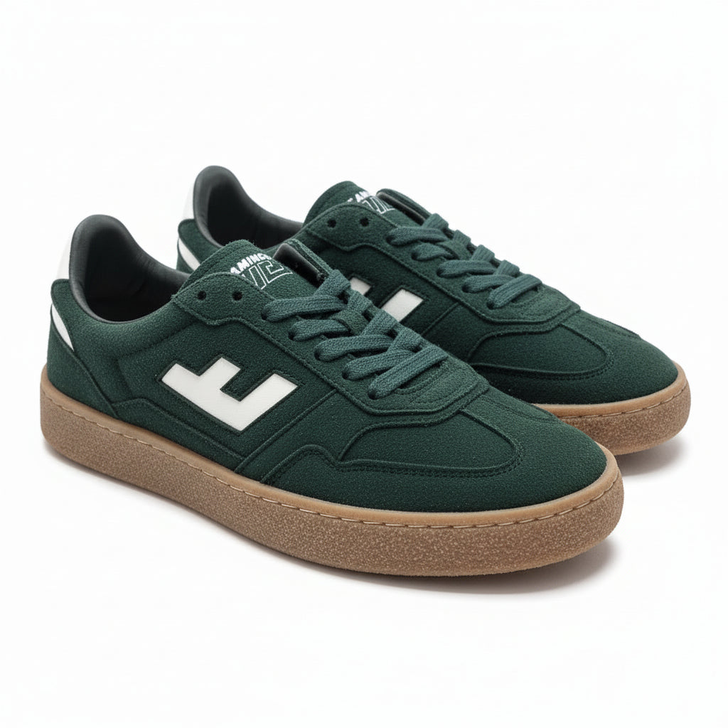 Ein Paar dunkelgrüne Turnschuhe mit weißen Akzenten, weißem Seitenlogo und braunen Gummisohlen, die auf einem hellgrauen Boden stehen.